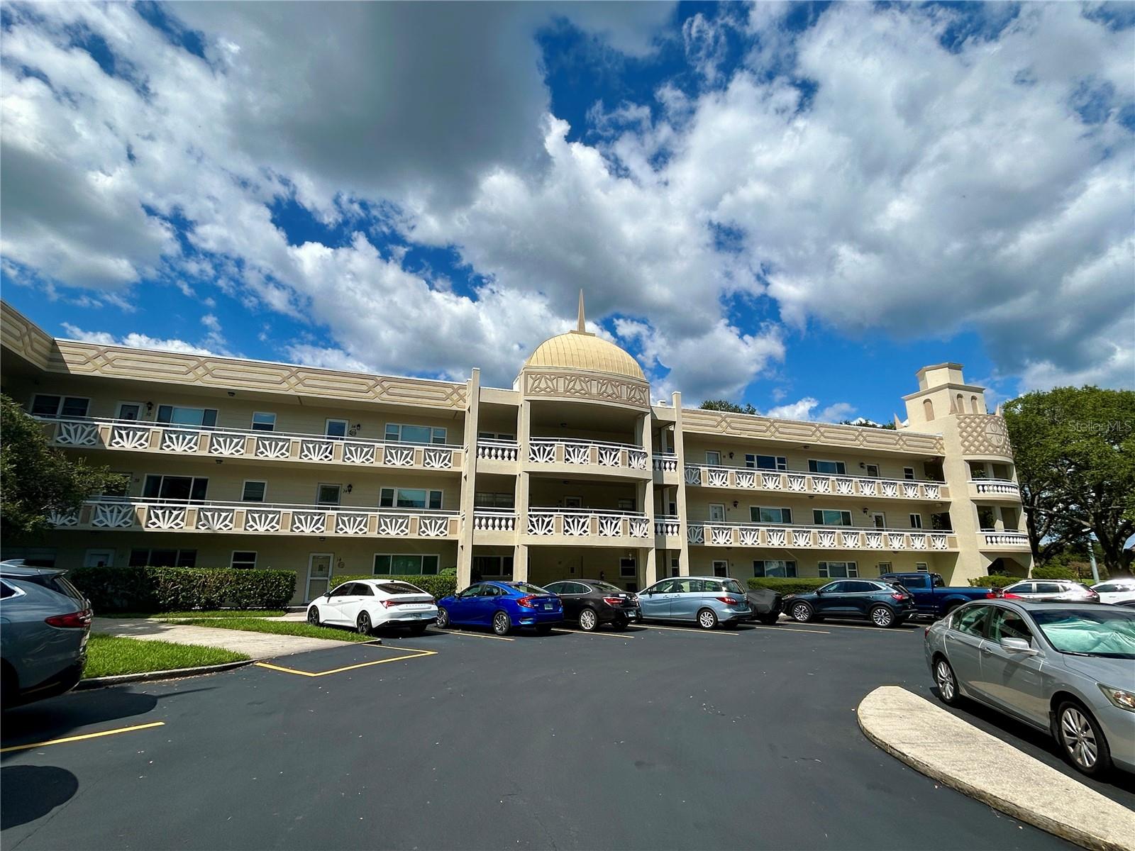 Enjoy the scenic view of the golf course fairways from this spacious, 2-bed, 2-bath, top floor end unit. The 'open concept' floor plan has an expansive Dining Room/Living Room/Florida Room area. The eat in kitchen features ceramic tile flooring with an adjacent pantry closet. Relax in the comfort and privacy of the large 17' x 13' primary bedroom and en suite bathroom. The unit includes updated windows, the HVAC was replaced in 2015, water heater in 2018, and ceiling fans are in all the main rooms to keep you cool. Located in a vibrant 55+ community, you'll have access to a wide range of amenities designed to enhance your lifestyle. Enjoy two private golf courses (9 and 18 holes), two heated swimming pools, and two activity centers. Stay active in the remodeled cardio gym or engage in various community activities like fitness classes, dancing, clubs, cards, and billiards. Pet owners will love the pet-friendly environment, featuring a fenced dog park and covered seating areas. Residents can also enjoy hobby studios and a woodshop for creative pursuits. The on-site Good Karma Café offers convenient 'take & bake' meals and snacks. Conveniently located near beaches, transportation, shopping, entertainment, and fine dining, this condo perfectly combines comfort with accessibility. Schedule your showing today and enjoy the best in comfortable and convenient living! Assigned parking. The 55+ community has two activity centers, and two private golf courses with 9 and 18 holes, free exclusively for resident owners. There are two heated swimming pools. The remodeled Cardio Gym has the latest exercise equipment. A very pet-friendly community, there is a fenced dog park with covered seating. There are hobby studios, and a wood shop for the exclusive use of the residents. Activities include fitness classes, dancing, clubs, cards, billiards, entertainment, classes, and much more. The on-site Good Karma Café has take & bake meals and snacks. Close to beaches, transportation, shopping, entertainment, and fine dining. All room sizes, floor plans and square footage are approximate. This property is being transferred by a leasehold estate deed. Association approval is required. If financing, a 35% down payment is required.