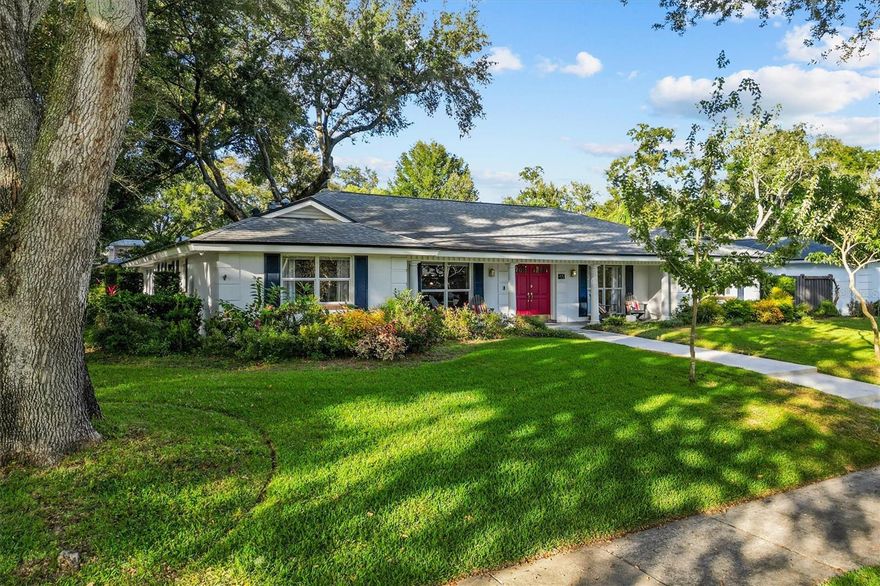 Tucked beneath the canopy of grand oaks in the iconic Southern Oaks community, this four-bedroom, two-and-a-half-bath beauty feels like a storybook home brought to life. Set on an oversized corner lot surrounded by lush, mature landscaping, it’s the kind of place where neighbors wave from porches and evening walks end under the golden sunset. From the moment you step onto the welcoming front porch—perfect for sweet tea sipping or unwinding at day’s end—you’ll feel the easy comfort that defines this home. Inside, a wide foyer opens to a sunken 1970s-style living area that now serves as a warm and inviting dining space. The kitchen is the true heart of the home—beautifully reimagined with gatherings in mind. A large cooking island with a drop-down vent anchors the space, flanked by dual pantries and a cozy coffee station with beverage refrigerators. Natural light spills in through the window overlooking the side yard, making even morning routines feel serene. Just beyond, the living area centers around a stone wood-burning fireplace, wrapped in the soft glow of Swedish White Oak flooring that flows seamlessly into the Florida Room. Here, walls of windows frame the lush backyard and pool, while custom built-ins add both charm and function—a perfect place to curl up with a book or enjoy the flowering plants. The primary suite offers a peaceful retreat with a generous walk-in closet and ensuite bath. Three additional bedrooms feature built-in closets, fresh paint, and new carpet, creating bright and welcoming spaces for family or guests. Step outside, and the magic continues. The backyard is a gardener’s dream—a living tapestry of hibiscus, amaryllis, azalea, camellia, and native flowering plants. Along the side fence, a Queen’s Wreath vine—lovingly nurtured since 2020—bursts into a cascade of blue-violet blooms each spring and early summer. Raised garden beds invite you to grow your own cut flowers or fresh veggies, and the heated saltwater pool with self-cleaning pump and separate hot tub make every day feel like a staycation. The side-entry garage keeps the front elevation picture-perfect, while offering overhead storage and direct access to a mudroom/laundry area with built-in cabinetry—just the right blend of beauty and practicality. Perfectly positioned just south of Downtown Orlando, this home offers the best of convenience and community. Zoned for Pershing K–8 and Boone High School, it’s surrounded by some of Orlando’s most sought-after amenities—shopping and dining in SoDo, the Dr. Phillips Center for the Performing Arts, Orlando City Soccer Stadium, and the Orlando Health complex are all just minutes away. And when it’s time to travel, the airport is an easy drive, making this location as connected as it is charming. Welcome home to Southern Oaks, where every day feels a little like a page from a storybook - 927 Wald Road is a home with heart—a place where traditional charm meets modern living, wrapped in the serenity of old-growth oaks and thoughtful details at every turn. Notable updates: Roof (2018) HVAC (2019) — ultra-efficient SEER 23 system, draws just 11 amps Minisplits in Florida Room & Primary Bedroom for added comfort Whole-house replumb (2022) Interior paint & new carpet (2025).