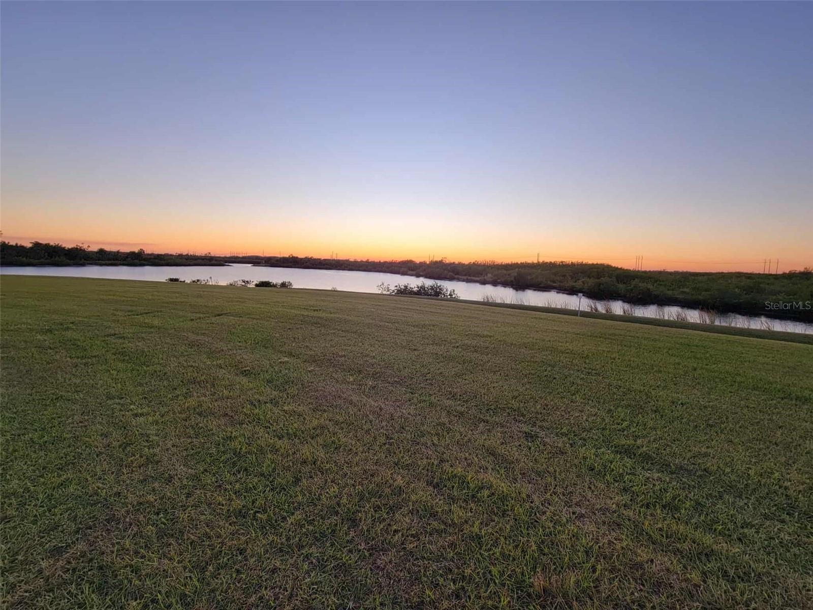 The Most Prestigious Lot in The Islands of Parrish Florida, premier gated waterfront and golf community where country club living meets the boating lifestyle. This rare homesite is an absolute unicorn. Large & pie-shaped, tucked away on a private cul-de-sac. Enjoy northwest sunset views over your own private lagoon with a cut to the Manatee River, surrounded by protected state land that ensures forever views and privacy.
Take your golf cart to the clubhouse, enjoy a round with friends, then step onto your boat for a sunset cruise — all without leaving the neighborhood. This lot is truly one-of-a-kind, offering size, orientation, and views unmatched anywhere in the community. Bring your own builder or choose from award-winning custom homebuilders currently building in The Islands.
Design your dream home on a property that will always stand out as one of the premier estates in the community, with lasting value and resale advantages from its exceptional location and setting. Conveniently located near Lakewood Ranch, I-75, Sarasota, and the Gulf Coast’s world-class beaches, dining, and shopping. This community and lot never flooded during 2024 hurricanes or any hurricane. Community has flood prevention drain systems built in for worry free living.