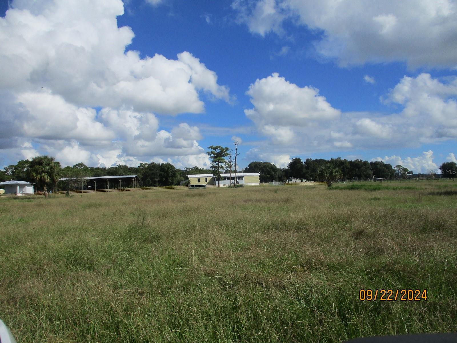 WELCOME to this exceptional 101.77+/-ACRE CATTLE RANCH/FARM, located in East Okeechobee, County, FL. This property has State road 710 frontage. This pristine, well kept ranch offers a 2 bedroom 2 Bathroom manufactured home 1865 sq.ft. TLA. A building that can be used for storage/workshop, A large pole barn with generous space to store hunting gear, ATVs, farm equipment, and more, keeping everything organized and protected. This 100-acre property is a rare find, offering a unique combination of natural beauty, Cattle ranch, and modern living accommodations. This property has everything you need to create unforgettable experiences.This property is fully fenced with many Palm trees, Oak trees, Pine trees throughout. It has Cattle pens, a well with solar panels.This property is zoned Industrial, It is not in a flood zone. Don't miss the opportunity to own this beautiful piece of property. Call today to schedule your tour of this beautiful ranch.