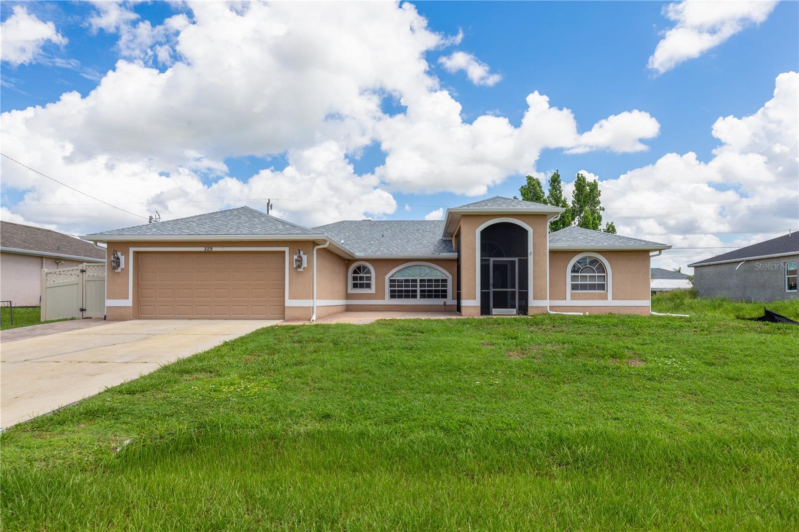 SPACIOUS 3 Bedroom, 2.5 Bathroom, 2 Car Garage, Pool home with a Family room located in Cape Coral. NO HOA FEES & NO FLOOD REQUIRED! CLICK ON THE VIRTUAL TOUR LINK 1 FOR THE VIDEO AND VIRTUAL LINK 2 FOR THE 3D TOUR. This lovely home features a bright & airy floor plan, tile flooring throughout, high ceilings, crown molding, and MUCH MORE! A versatile front patio is perfect for sipping your morning coffee, tending a patio garden, or simply relaxing and enjoying the fresh air. Enjoy a no-seeum screened front entry that creates a breezy, bug-free welcome into your home. The open-concept living and dining area is ideal for entertaining friends and family, featuring a large glass pocket slider that seamlessly connects the space to the lanai. The kitchens offers an 2024 appliances including an electric cook top and built in oven, kitchen Reverse Osmosis system, granite countertops, a closet pantry, a breakfast bar and a dinette. Expand your living and entertaining space with the generously sized Family room off the kitchen. The spacious master suite has a glass slider to the lanai, DUAL walk-in closets and a private bathroom with HIS & HERS split vanities, a walk-in shower with multiple shower heads, and a jacuzzi soaking tub. The guest bedrooms are on a split floorplan, providing plenty of privacy, with built in closets and a nearby guest bathroom. Expand your living and entertaining space to the spacious lanai, the perfect for hosting weekend barbeques, casual outdoor dining or unwinding with your favorite evening beverage. Protected by no-see-um screens, you can relax comfortably without the nuisance of bugs. Soak up the Florida sunshine from the pool deck, or lounge in style in your private HEATED saltwater pool. After a swim, rinse off in the private outdoor shower, and enjoy the convenience of a poolside half bathroom—perfect for guests and effortless entertaining. The partially fenced backyard has a paver patio—a practical space for a grill, outdoor seating, or small gatherings. Low-maintenance and functional, it offers just enough room to enjoy the outdoors without a lot of upkeep. 2024 ROOF - SOLAR ATTIC FANS - NO SEE-UM SCREENS ON FRONT & BACK LANAI - 2024 A/C & AIR HANDLER - WATER SOFTENER. Conveniently located close to local shopping & boutiques, fine & casual dining, LIVE entertainment, and a short car ride to award-winning beaches! Schedule your showing TODAY!