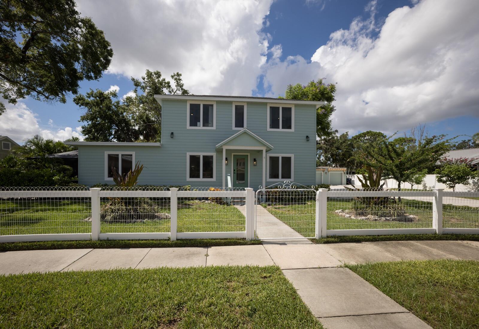 Timeless 1900 Historic Gem in Palmetto’s Coveted River District!!! Step into a perfect blend of historic elegance and modern luxury with this fully remodeled 1900s masterpiece, ideally located in Palmetto’s sought-after historic neighborhood—just moments from the shimmering waters of the Manatee River. Completely Reimagined, Inside and Out. The current owners spared no expense in bringing this home to the highest standards. Upgrades include a NEW roof, NEW siding, NEW impact windows and doors, NEW pool and spa, NEW tankless water heater, NEW flooring, NEW kitchen appliances—and so much more! This 4 bedroom, 2.5 bath home with a detached 2 car garage offers all the character of a historic residence with the comfort and convenience of modern living. From the moment you arrive, you’ll be charmed by the fresh coastal façade, framed by a white picket fence, lush tropical landscaping, and the shade of a majestic 300-year-old oak tree. Sunlight pours through brand-new impact windows, illuminating gleaming French marble floors. The open floor plan is anchored by a beautifully restored dining room fireplace—a nod to the home’s rich past. The remodeled kitchen is a showpiece with sleek black granite countertops, warm wood cabinetry, stainless steel appliances, open shelving, and a dedicated coffee/prep nook. Multiple living spaces, including an airy sitting room and a cozy family room, offer flexibility and flow. The downstairs primary suite offers a stunning spa-inspired bath with a new vanity, Toto toilet, and a glass-enclosed walk-in shower. A second downstairs bedroom can double as a home office. Upstairs, you’ll find two additional bedrooms and 1.5 baths.. Truly Resort-Style Outdoor Living! Within the past few years, a stunning pool and spa were added, creating a backyard retreat perfect for entertaining. Surrounded by tropical landscaping and enclosed in a screened lanai, the pool area offers multiple seating spaces for lounging or gathering. A screened-in porch off the back of the home is perfect for peaceful mornings, while a spacious deck is ideal for grilling and outdoor dining. A Lush, Private Paradise awaits you out back! The expansive fenced backyard is shaded by the giant oak and dotted with palms, blooming jacarandas, native avocado trees, and rare African fruit trees—offering both beauty and privacy. It’s the perfect setting for pets, play, or simply enjoying the Florida lifestyle. This one of a kind property offers the charm of history, the luxury of modern updates, and the freedom of no HOA or deed restrictions. There’s plenty of room for a boat or RV, and the riverfront is just a short stroll away.