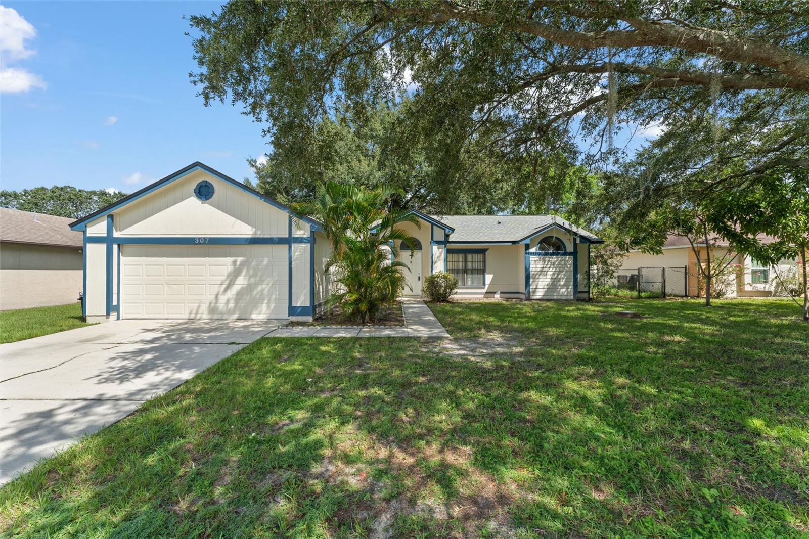 **This house comes with a REDUCED RATE through the seller's preferred lender. This is a lender-paid rate buydown that reduces the buyer's interest rate and monthly payment.** Step inside this inviting 3-bedroom, 2-bathroom single-family home offering nearly 1,600 sq ft of well-designed living space in the heart of Kissimmee. From the moment you walk through the front door, you're greeted with an open and airy living and dining room combo that sets the tone for effortless living and entertaining. The split-bedroom layout ensures privacy, placing the spacious primary suite just off the living room. Enjoy direct access to the backyard through sliding glass doors, and unwind in your ensuite bathroom featuring a walk-in shower, step-in soaking tub, and an extended vanity with seating space—your personal retreat after a long day. Move seamlessly through the main living area to the kitchen and cozy family room, perfect for everyday living. With direct access to the 2-car garage, the kitchen offers convenience, while another set of sliding glass doors fills the space with light and leads you to the backyard oasis. Down the hall, you'll find two additional bedrooms, both with built-in closets, and a full bath with a classic tub-shower combo—ideal for family, guests, or a home office setup. Step outside and enjoy the shade of a gorgeous mature tree, and imagine the endless potential of your blank canvas backyard—perfect for a garden, patio, playset, or even a pool. Whether you're a first-time buyer, downsizing, or looking for a rental-ready investment, this home is full of charm and ready for your personal touch. Don’t miss your chance—schedule your private showing today!