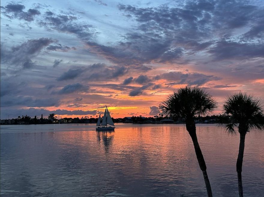 Don’t miss this rare opportunity for LUXURY WATERFRONT LIVING! Exceptional Top-Floor Condo with PANORAMIC WATER VIEWS. Discover this truly one-of-a-kind, nearly 2,000 sq. ft. residence overlooking the Pass-A-Grille channel. COMPLETELY RENOVATED with thoughtful upgrades throughout, this spacious home blends luxury, comfort, and peace of mind. Step into a bright open layout designed for both entertaining and everyday living. The chef’s kitchen features soft-close cabinetry, granite counters, and GE appliances with transferable warranty. Enjoy multiple living and dining areas, a spacious laundry room, and a flexible den/office space. The home offers travertine flooring throughout, hurricane-rated windows and doors and THREE FULL EN-SUITE BEDROOMS, including a newly renovated bathroom in the primary bedroom, plus generous walk-in closets. Open your sliding glass doors to a screened lanai and take in endless views of dolphins, stingrays, and passing boats. The inviting outdoor space creates the perfect setting for relaxation or hosting family and friends. Additional perks include two under-roof dedicated parking spots, two storage closets on the second floor, and condo fees have remained stable for over two years. This top-floor sanctuary combines modern upgrades, breathtaking views, and resort-style amenities in a community that continues to invest in its future. Motivated seller offering to pay for 1 full year of condo fees.