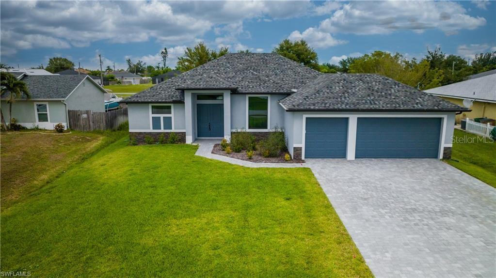 RATE BUYDOWN INCENTIVE – Estimated Payment as Low as $2,300/Month! Discover this brand-new, beautifully crafted home with city water and sewer, located in a non-flood zone for added peace of mind. Built with hurricane-impact windows and doors, this residence offers both safety and style. Featuring 3 spacious bedrooms plus a large den and 2 full bathrooms in a desirable split-bedroom layout. The heart of the home is a gourmet kitchen with a granite-topped island, tile backsplash, stainless steel appliances, pantry closet and white shaker soft-close cabinetry, creating a clean, elegant look. The open-concept design includes a 12-foot tray ceiling in the expansive living area, seamlessly flowing into a separate dining or breakfast nook—perfect for entertaining. Luxury plank flooring extends throughout the home, and a large sliding door invites abundant natural light and provides easy access to your covered lanai, ideal for enjoying the Southwest Florida sunshine. The guest wing includes two bedrooms and a full bathroom with direct lanai access—great for future pool plans. The primary suite is a true retreat, featuring a tray ceiling, sliding lanai doors, dual walk-in closets, and a luxurious en-suite bathroom with a walk-in shower, garden soaking tub, dual vanities, shaker cabinets, and a private water closet. Step outside to the spacious, covered lanai with an outdoor ceiling fan, creating the perfect outdoor living space. This home is nestled in a highly desirable neighborhood with no HOA fees, giving you the freedom to live—or rent—on your own terms, without added rules or monthly dues. You're just minutes from fine dining, boutique shopping, grocery stores, banks, medical offices, parks, and marinas—everything you need is within easy reach. Plus, you're a short drive to some of Southwest Florida’s most iconic coastal gems—Sanibel, Captiva, and Fort Myers Beach—making weekend beach escapes, scenic sunsets, and waterfront dining part of your everyday routine.