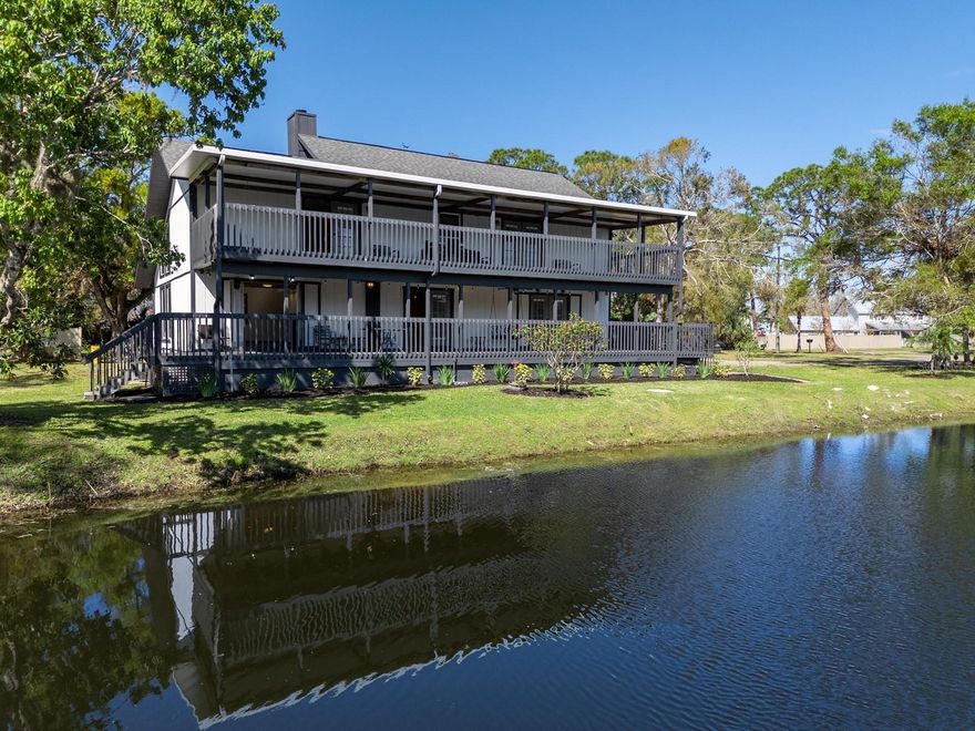 One or more photo(s) has been virtually staged. A private lakefront retreat nestled on 1.8 acres right in the heart of Sarasota! This serene sanctuary provides the perfect blend of seclusion and accessibility, inviting you to escape the hustle and bustle while being close to all the amenities you need. Located west of I-75, near Cattleman Road, this property has 4-5 bedrooms, a den/study, 3 bathrooms, and a detached, climate-controlled 1500 square foot garage that accommodates 4-5 cars, offering endless possibilities. The hobbyist will find it a versatile workshop, while the visionary can adapt it to meet their needs, enhancing its potential and value. The main house has a wraparound porch surrounding the first floor, featuring three French doors blending the indoor and outdoor spaces. A great room combines living and dining areas and boasts clerestory and twin picture windows, two-story ceilings, and a wood-burning fireplace. The kitchen is fully equipped with nearly new stainless-steel appliances from GE. It has ample cabinetry designed in a farmhouse style, complete with stained glass accents. Additionally, there is a built-in pantry and under-stairs storage for even more convenience. A center island on tiled flooring includes a breakfast bar and extra cabinets for added organization. A separate den/study has double pocket door privacy, window bench seating, and direct access to one of two primary bedrooms. This first-floor suite overlooks the lake and has a built-in closet. This wing also includes a flex room that could be converted into a beautiful walk-in dressing closet (refer to the virtually staged photo). The updated bath has room for an enlarged vanity to accommodate double sinks. This area could be transformed into the ideal first-floor Owner’s suite by integrating these rooms with continuity. A landing on the second floor leads to the bonus room, which overlooks the main living area. The primary suite on this floor has been upgraded and features a balcony and a walk-in closet. A stylish barn door separates the en suite bathroom, which includes a free-standing vanity, dual sinks, and a spacious walk-in shower with a glass door. Upstairs is an updated bathroom and two additional bedrooms, each featuring a walk-in closet, a laundry room, and French doors to a balcony. Step onto one of the two decks to experience stunning sunrises over the lake. The lower deck has just been reinforced and refurbished. The house is said to contain a 3-foot concrete block wall and concrete pads supporting steel floors and beams, originally built to accommodate these beams for added structural support. Surrounded by stately oaks on an expansive piece of land, this remarkable home offers plenty of room for outdoor activities and the possibility of adding a pool without any deed restrictions. So, bring your boat and RV! The location is near Detweiler’s Farm Market, UTC shopping, and various dining destinations. It is also close to several county parks, including the Celery Fields, which borders Ackerman Park. This 360+ acre area is well known to locals for its diverse wildlife and wetlands, providing opportunities for nature watching and exploration. Visitors can enjoy activities such as walking along two boardwalks, fishing, and kayaking.