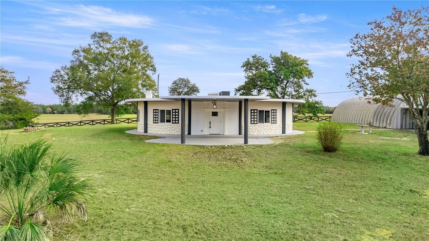 Completely remodeled - everything is new - bring the horses & toys and move right in! Super location only 15 minutes to HITS,  20 minutes to The World Equestsrian Center.  (WEC), 15 min to Goethe State Forest, and 20 min to Rainbow Springs State Park.  The unique style & construction of this one-of-a-kind round house maximizes the usable square feet & significantly improves energy efficiency.  Constructed of concrete, concrete board & stone, and a roof constructed of approximately 12' of concrete, this home is insulated and solid! The gorgeous,  open floor plan offers an abundance of natural light and features: large living room with rounded wood burning fireplace with heatilator, spacious eat-in kitchen w/breakfast bar, pantry, granite counters, and stainless-steel appliances; master bedroom with walk-in closet and en-suite bath with walk-in tile shower; 2 guest bedrooms (one with walk-in closet, one with built-in closet); guest bath; inside laundry with storage closet; and a large covered front porch overlooking the property. This gorgeous fully fenced and gated 2.5 acres also includes a 1200 sf Quonset Hut with 360 sf carport; a 512 sq shed with carport that includes 3 separate workshops/storage areas; plus another a 360 sq ft. carport. This property backs up to a huge farm and offers gorgeous views of the surrounding properties. A gorgeous and unique opportunity to create your own mini-farm and own 2.5 acres with a completely remodeled home offering room for you, your hobbies, and your animals!