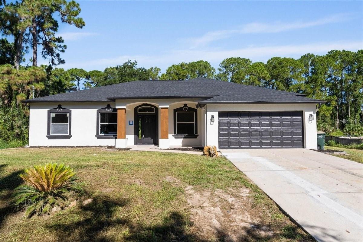 Located in the sought-after North Port area, this fully renovated 3-bedroom, 2-bathroom home is a standout. It features a new roof, A/C, garage doors, fresh paint inside and out, and new luxury vinyl flooring throughout. The stunning kitchen boasts a blue island with radiant quartz counter- tops, 26-inch shaker-style cabinets, and a beautiful glass backsplash. The spacious family and dining rooms are filled with natural light. The primary bedroom accommodates a king-size bed with ample space. The updated bathrooms feature mosaic-tiled showers, a freestanding clawfoot tub, and new mirrors, light fixtures, and vanities.
