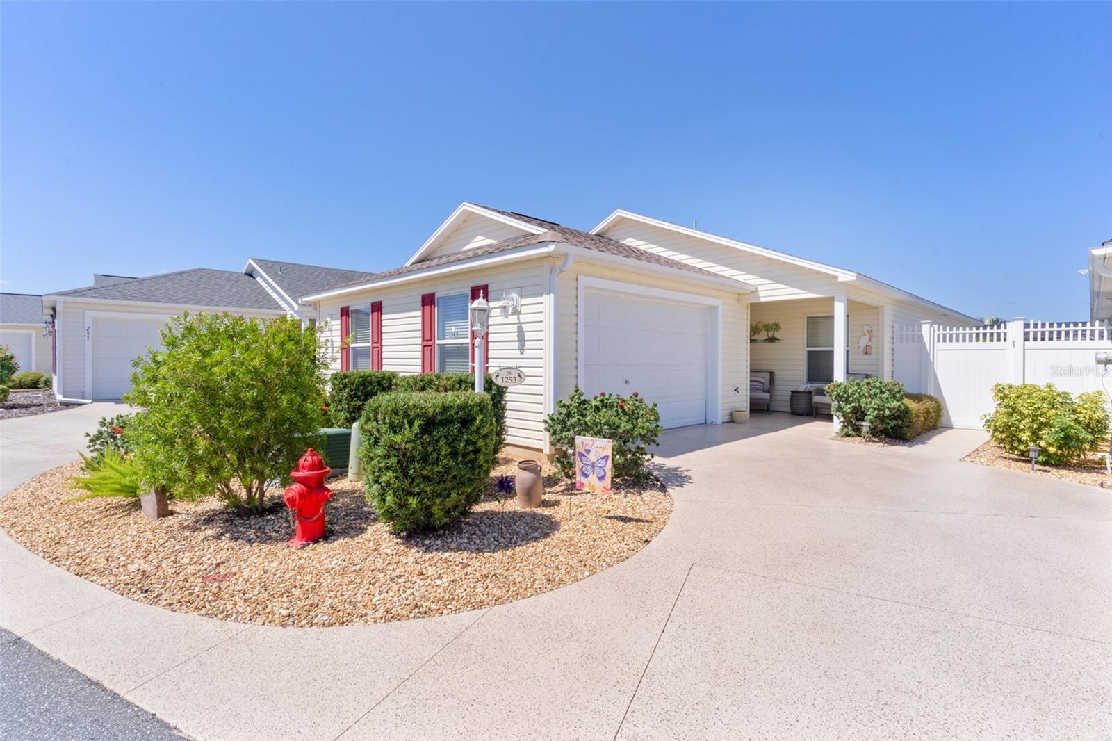 Welcome to the Village of Dunedin. This TURNKEY Carabelle Courtyard Villa is located in the desirable Whitney Villas. As you approach this home, take note of the well-manicured shrubs accented with decorative river rock and an inviting patio area. Upon entering, you’ll find a bright open floor plan with vaulted ceilings and no carpet. In the kitchen area, the beautiful blue cabinets add a stylish touch and bring a fresh pop of color to the space. The living and dining area features neutral-colored walls, luxury vinyl flooring, and tasteful décor, creating a warm and inviting setting that’s perfect for relaxing or entertaining. The primary bedroom offers soft-colored walls, a spacious walk-in closet, and an ensuite bath with a walk-in shower. An added feature—direct access to the outdoor lanai, letting you step right into your private backyard retreat. There’s also an additional bedroom—ideal for guests, a TV room, or even a home office—with an adjacent bathroom for added comfort and flexibility. Step outside to a beautifully designed covered lanai that seamlessly extends into a spacious screened area—perfect for year-round relaxation or hosting gatherings. This inviting outdoor retreat provides the ideal balance of shade and fresh air, with ample room for comfortable seating, dining, or entertaining guests. Beyond the lanai, an enclosed courtyard offers extra privacy and versatility, making it a perfect spot for morning coffee, evening cocktails, or enjoying the Florida lifestyle in comfort and style. This home is about easy, move-in ready living. The location is ideal-just between Evans Prairie and Belle Glade Country Clubs, and a short golf cart ride to Colony Plaza or Brownwood Paddock Square for shopping, dining, and entertainment. Offered turnkey, this villa is ready for you to start living The Villages dream from day one.