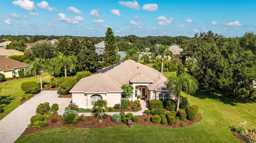The first time offered for sale since new, this Natchez model home with 3 bedrooms, 2 baths is located in the extremely convenient location of Bridgeport at Lake Sumter, an all-premier single home village just north of the town of Lake Sumter Landing. This particular home sits on an almost one-half acre on a cul-de-sac street of impressive homes, and it has plenty of room for a future pool if desired. The neighbors benefit from the three productive Meyer lemon trees and the papaya tree on this property. This premier model block and stucco home is architecturally pleasing at first glance with its large arched front windows, side load garage and bricked drive and walkway. Looking inside the home, the tall ceilings throughout the home give a spacious feeling, and the engineered hickory flooring in the main living area and primary bedroom add interest and warmth. The crown molding in all the rooms and the shutters on all the home’s windows give this home a finished look. The generous kitchen has numerous fruitwood cabinets, granite counters, newer stainless appliances and a center island. For casual dining there is barstool seating at the counter and a separate spacious kitchen eating area. The great room incorporates both the larger dining area and living area of the home and features a tray ceiling. Continuing through the home, the primary bedroom is a generous sized room both gracious and relaxing with a tray ceiling and engineered wood flooring. The primary bath with its double sinks and granite counters is notable for its Jacuzzi brand, 1 person sauna which the owner attests greatly has contributed to his longevity. Two guest bedrooms, both with closets, and a guest bathroom are positioned on the opposite side of the home for privacy. A separate laundry room is conveniently located near both the kitchen and the garage. The enclosed lanai, 18 x16, offers a private retreat and a great view of nature. New roof-2020, new gas water heater-2016, new HVAC-2023. The BOND PAID.  One year Broward Home Warranty is included. This home, priced to sell, allows a new owner to enjoy the friendly neighbors on this cul-de-sac street and to live in this very convenient active village at a truly reasonable price. Please stop by soon to decide if you could be the new owner of this premier Villages home!