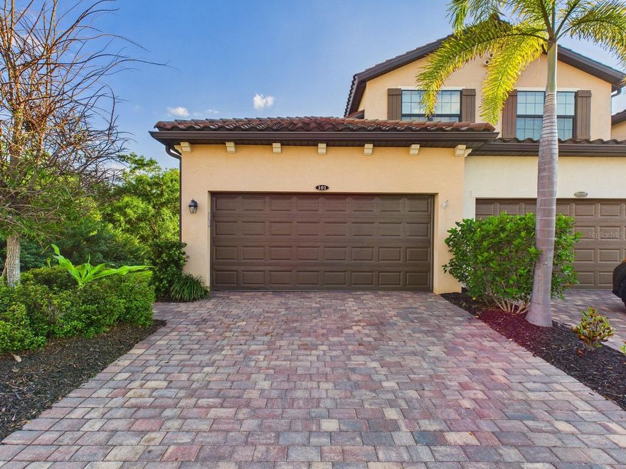 Nestled behind the gates of Gran Paradiso, this beautifully appointed coach home offers a perfect blend of comfort, privacy, and resort-style living. As a desirable end unit, it enjoys a unique setting bordered by a natural preserve on one side and a pond on the other, creating a serene backdrop that enhances both tranquility and scenic beauty. The screened lanai, accessible from the main living area, invites you to relax and unwind while taking in breathtaking sunset views. This inviting outdoor space also provides direct access to the primary suite, seamlessly connecting indoor and outdoor living. The primary bedroom itself is generously sized, offering a peaceful retreat complete with two spacious closets and a well-appointed ensuite bathroom featuring dual vanities and a curb-free, glass-enclosed shower. Inside, high ceilings elevate the sense of openness, filling the home with natural light and an airy ambiance. The thoughtfully designed floor plan promotes a smooth, effortless flow between spaces, making everyday living as well as entertaining feel both comfortable and refined. The spacious kitchen is equipped with abundant counter space and ample cabinetry, ideal for preparing meals or hosting gatherings, while the adjoining great room serves as a welcoming hub for dining and relaxation. Whether you're enjoying quiet mornings on the lanai, hosting friends and family, or taking advantage of the plentiful amenities within Gran Paradiso, this coach home presents an exceptional opportunity to embrace the very best of the Florida lifestyle.