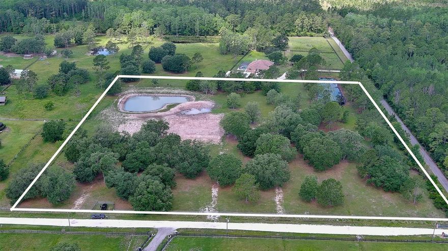 BUILD your Country ESTATE home here! Beautiful, high & dry (X Flood Zone) 10 acre lot in Saddle Brook Farms, New Smyrna Beach! This amazing corner lot is fully fenced, has the beginning phases of house and garage pad, driveway, two gated entrances, newly excavated heart shaped pond in SW corner, and over 25 mature Oak trees! Great location towards the back of the community giving extra privacy! Minutes to Deep Creek Preserve, Palm Bluff Preserve, Lake Ashby Park for hiking, fishing, camping, boating, picnics with playground, 10 minutes to the East Coast Rail Trail head in Osteen for bicycle enthusiasts and 25 minutes to the Sanford Airport or beaches in New Smyrna Beach! Horses, cows, sheep, goats welcome! Lot size is 656x665. Deed restricted community. Survey Available! No hoa fees. Zoned A-1, single family residence.; Cleared: Partial