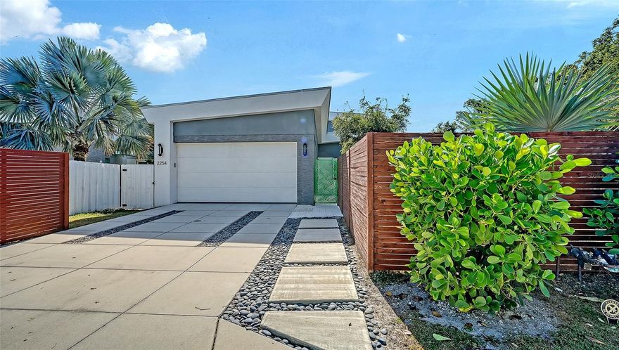 LOCATION! LOCATION! LOCATION! This beautiful contemporary home is conveniently located 2 blocks from the hospital and a few minutes from downtown Sarasota. Newly built in 2018, the residence features 3 bedrooms, 2.5 baths, a gigantic lanai, soaring ceilings, expansive windows, and an abundance of natural light that fills the open-concept layout with an airy, inviting ambiance. High-end cabinetry and sleek finishes enhance the sophisticated interior, while a versatile second-floor loft offers endless possibilities for a home office, fitness area, art studio, or guest retreat. Built above the flood zone and outfitted with hurricane-impact windows and doors, the home offers both beauty and long-term peace of mind.  The fully fenced, lush yard provides privacy and is ideal for pets. You will enjoy your walk around Arlington Park and the vibrant Southside Village.
