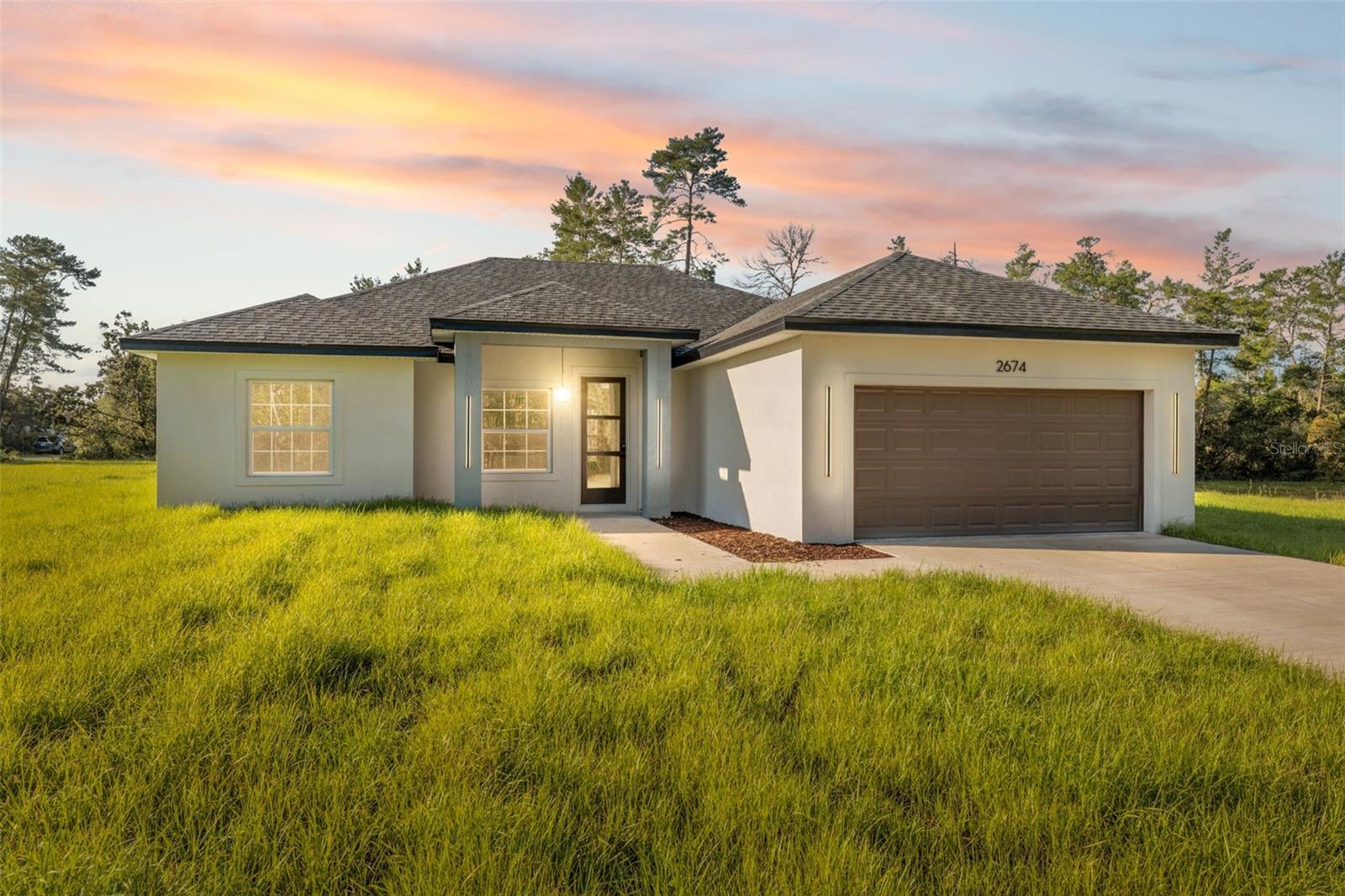 Gorgeous New Construction on Oversized Corner Lot in a Prime Ocala Location!
This brand-new home combines modern design, comfort, and functionality—all set on an oversized corner lot in one of Ocala’s most desirable areas.
Enjoy added privacy, more yard space, and enhanced curb appeal with this rare corner lot location—ideal for families, entertaining, or future additions like a pool or garden.
Featuring 4 spacious bedrooms and 2 beautifully finished bathrooms, this home offers an open-concept layout that feels bright and inviting from the moment you walk in. The large living area flows effortlessly into the dining space and kitchen, creating the perfect setup for entertaining or relaxing with family.
Sliding glass doors bring in plenty of natural light and open up to the backyard, offering a seamless indoor-outdoor living experience. The kitchen is a true highlight, with stone countertops, solid wood cabinetry, and generous prep and storage space—ideal for any home chef.
The primary suite is both spacious and private, featuring a walk-in closet and a stylish en-suite bath. Three additional bedrooms offer comfort and convenience, each with built-in closets and plenty of natural light.
Additional perks include a 2-car garage, quality finishes throughout, and a layout designed for everyday living. And with the expansive corner lot, you’ll enjoy more room to spread out—both inside and out.
Located close to major roads, schools, and shopping, this home offers the perfect mix of peace and accessibility.
Don’t miss this opportunity—schedule your private showing today and make this stunning new home yours!