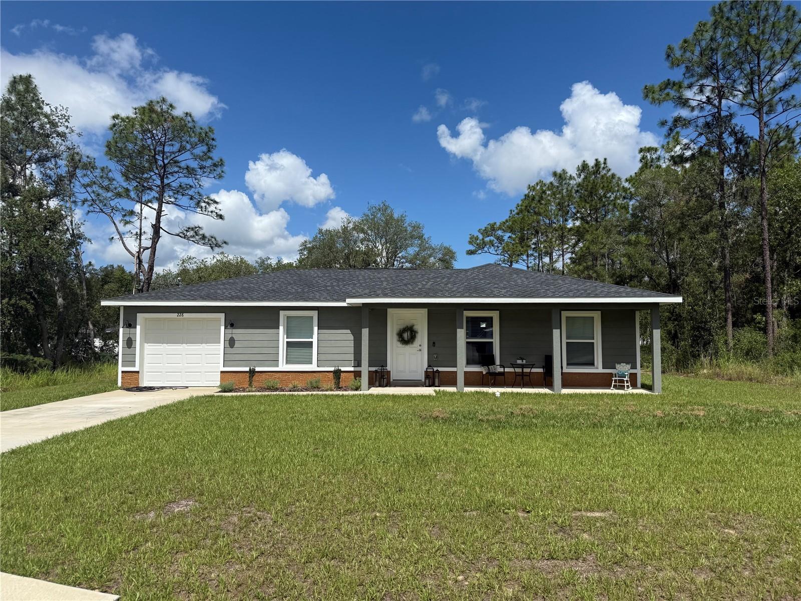 Nestled in a serene neighborhood, this split-plan home boasts a cathedral ceiling, laminate flooring, concrete block construction, a private well, and a spacious 20’x5’ front porch for relaxation. It’s an ideal place to start a family or retire.
