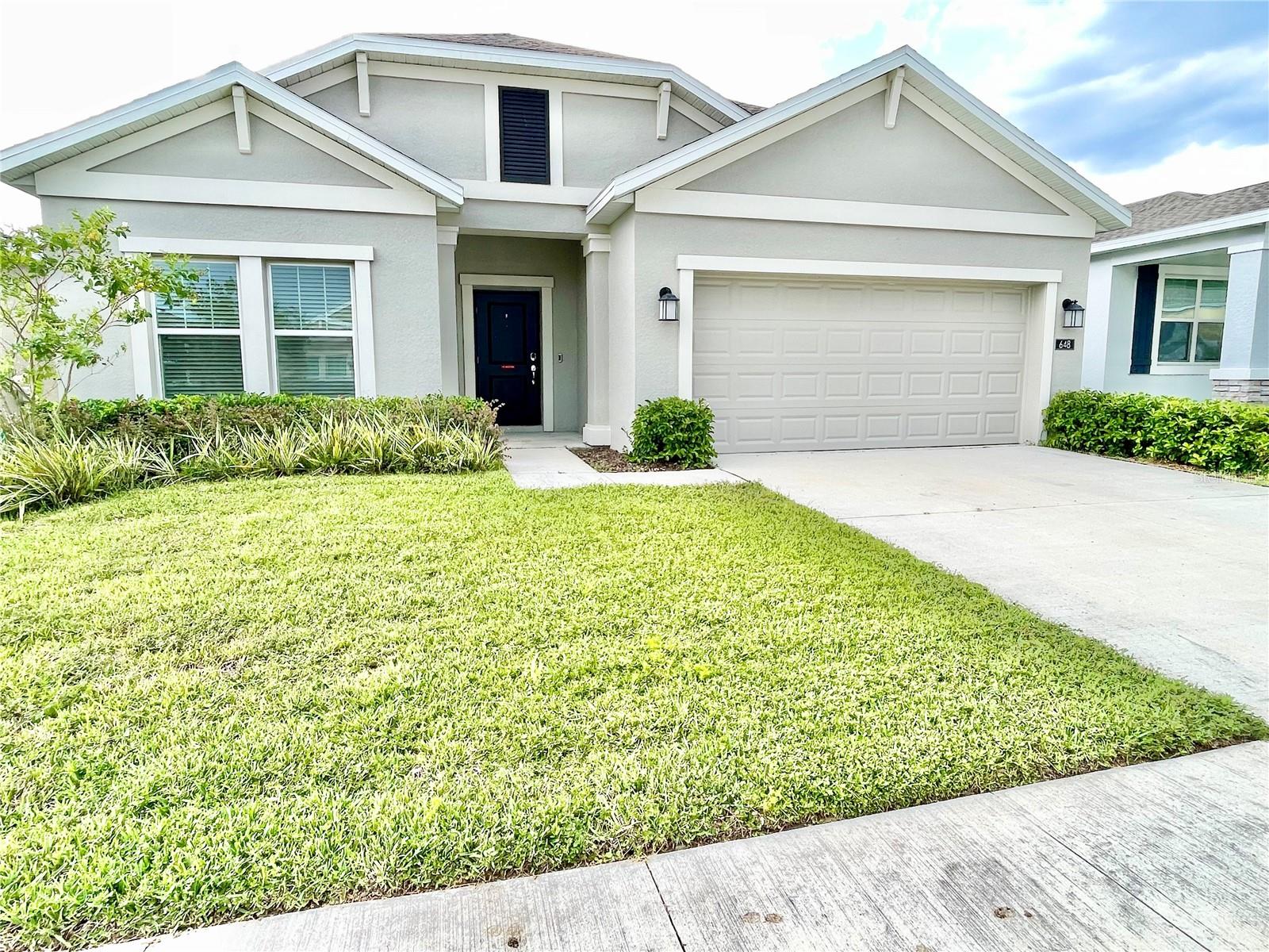 One or more photo(s) has been virtually staged. Welcome to this 2023 Astonia North community home offering a 4 bedroom and 2 bath with a 2-car garage located in the most sought-after neighborhood in Davenport. Nestled about 8 minutes from Posner Parc, and close to I-4 and Walt Disney World, in addition to all the major hubs in Central Florida. This 2023 Home is built with many upgrades, including the solar panels that greatly reduce your Power Bill for only ($69.00) monthly. A lawn with a couple tropical fruit trees and planter boxes; a screened in covered lanai, a video security system, stylish ceiling fans in all bedrooms and living room. Amenities include a resort-style swimming pool, playground. A must see, better yet a must buy!!