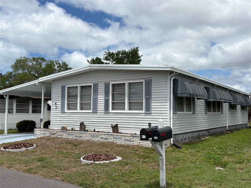 Looking for a  55+ mobile home community with lots of activities and amenities? Venice Isle, just off US41, is the place for you. This double wide manufactured home is located on a quiet street and has a nice backyard which many of these homes do not. The Carport is brand new as of early 2025. It houses a lanai area which can be screened in, as well as, a shed which contains a washer/dryer, workbench, and lots of tools. The home has a brand new Carport, newer plumbing, newer roof-over, new flooring, newer bathrooms, and updated kitchen.  You can enter the home through the first door which leads you to the kitchen and what was the original Florida Room, or you can enter further down to a door that leads you to the dining room and kitchen. Spacious kitchen with lots of white soft-close cabinets. It includes a dishwasher, stove/range with microwave, refrigerator and cute window above the sink and a sun tunnel above. Counters are solid-surface white with a bar area for parties or a quick bite. Next to the kitchen as you enter is the dining room with a built-in display cabinet and a sun tunnel between the kitchen and dining room.  Beyond the dining room is the living room which has been extended by the enclosed Florida Room. Windows in the Public area have lovely custom shades which provide privacy but also filtered light. Flooring is vinyl throughout and both bathrooms have been updated. All furniture conveys, however, there is no bed in the Primary Bedroom. Seller is leaving 3 televisions, furniture, and household items. This home is ready for you to make it your own. If your not busy at the pool or doing other of the many activities  in Venice Isle, you can go to downtown historic Venice which is about 15 minutes away. Going the other direction on US41, you can head to Wellen Park with its 80-acre Grand Lake and nature trails. Cool Today Park with the Atlanta Braves Spring Training Stadium is just 5 minutes from Wellen Park. Enjoy Spring Training and other events there throughout the year. Of course, you have the many Gulf beaches which are are a short drive away. The Sarasota Memorial Hospital, Venice Campus, is just 20 minutes away as well.
