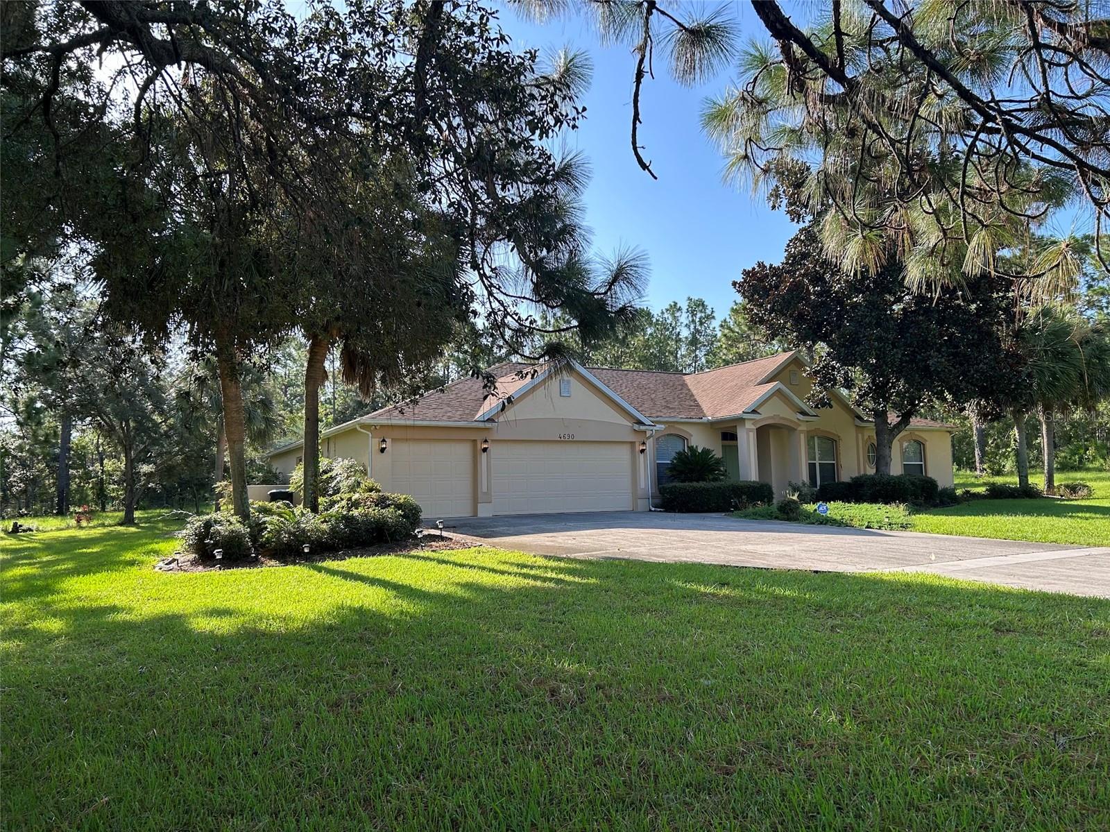 A four-bedroom, three-bathroom, open-concept home with three-car garage in a serene equestrian development, featuring two master suites with en-suite bathrooms, screened-in lanai with swimming pool and hot tub, surrounded by lush azaleas and hydrangeas. Available furnished or unfurnished.
Nestled in a tranquil equestrian community, this Florida paradise welcomes you with vibrant azaleas and hydrangeas throughout the manicured landscape. The single-story home features a bright, open-concept interior with soaring ceilings, large windows, and sleek tile floors that flow seamlessly from the living area into a modern kitchen with gleaming appliances, spacious island, and ample cabinetry.
Two master suites set this home apart. The primary master features plush carpeting, a boutique-style walk-in closet, and an en-suite bathroom with soaking tub, glass shower, and dual vanities. The second master suite offers its own en-suite bathroom and flexible space suitable for guests, extended family, or a home office. Two additional bedrooms share a third full bathroom with modern fixtures.
Beyond the sliding glass doors lies a screened-in lanai with sparkling swimming pool and hot tub—ideal for relaxation or entertaining. The shaded lanai is well-suited for outdoor dining while watching stunning sunsets.
This equestrian development offers quiet streets ideal for walking, with trails and open spaces for horse lovers. Florida's famed springs are just minutes away, providing crystal-clear waters for kayaking, swimming, and adventure. Nearby hiking trails wind through lush forests, while local restaurants range from cozy diners to upscale bistros.
Available fully furnished, this estate offers flexibility to suit any buyer's vision. The open layout invites gatherings, dual master suites provide options, and the established community creates a sense of belonging.
What's next? Perhaps a tour, a closer look at the lanai where you'll host your first barbecue, or a stroll through the neighborhood to meet the welcoming neighbors. The story of this beautiful home is just beginning, and it's waiting for someone new to call it home.