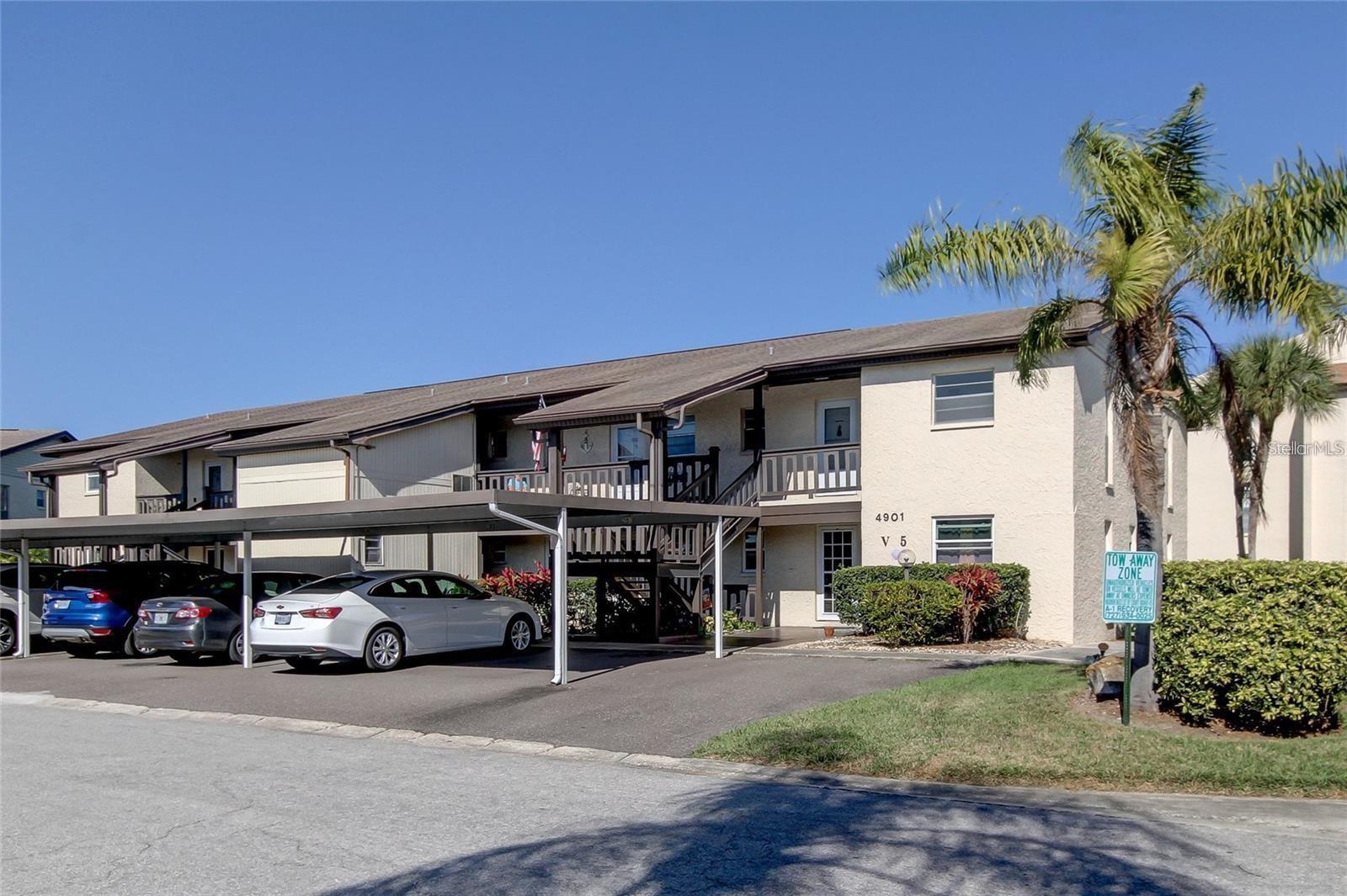 Live the Florida Lifestyle and enjoy sunsets from your second story condo in this well maintained community for all ages. This end unit has plenty of light and spaciousness in a renovated 2 bedroom/1 bath floor plan with over-sized closets, an amazing sun-room, extra storage closet for your beach gear, reserved covered parking, laundry facility for each building, and a new A/C unit (June 2025). Gulf Harbors Condominiums offers 2 swimming pools, shuffleboard grilling areas and a kayak launch. Join the Gulf Harbors Beach Club (only $180 per year) for membership to one of the only private beach clubs on the Gulf of Mexico with pavilions, grills, showers and bathrooms. HOA fee includes: Internet, Sewer, Trash, Water, Community Pool, Escrow Reserves Fund, Maintenance Exterior, Maintenance Grounds, Pool Maintenance, and Recreational Facilities. Buyer to verify all measurements, HOA requirements, and land, site and tax information.