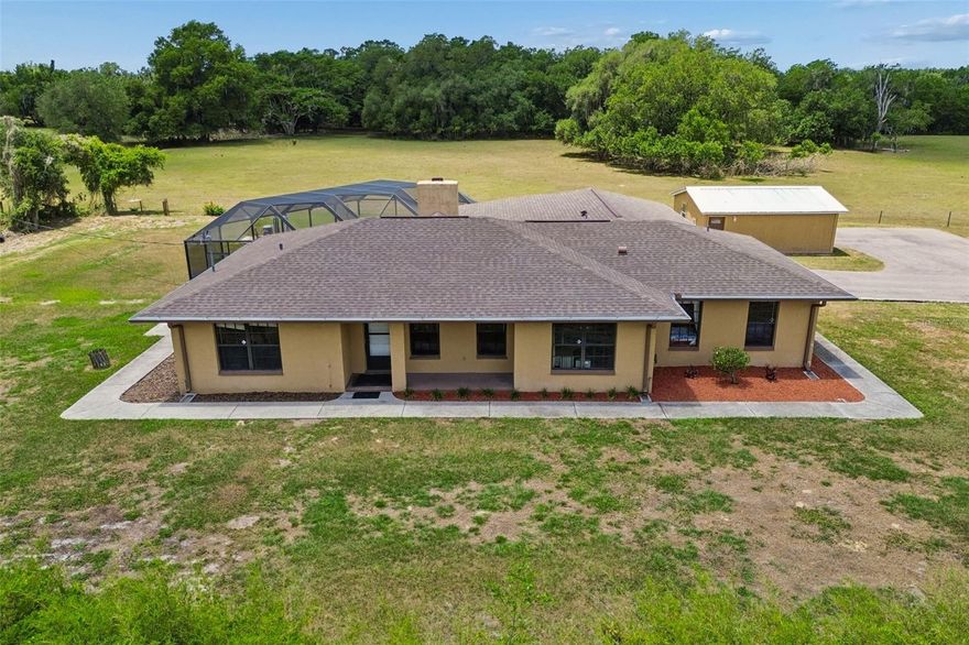 Welcome to your own private retreat, where country living meets everyday convenience on just under 1.25 acres. This 3 bedroom, 2 bath pool home offers a rare combination of space, flexibility, and functionality. The property features a detached in-law apartment complete with its own private bathroom, ideal for guests, multi-generational living, a home office, or additional income potential.
Inside, the home offers a warm and inviting layout highlighted by a cozy fireplace and comfortable living spaces designed for both everyday living and entertaining. Step outside to enjoy the pool, expansive outdoor space, and peaceful setting that provides privacy while still being conveniently located near shopping, dining, and major roadways. Additional highlights include a newly paved driveway, ample room for parking, and endless potential for those seeking a property with room to spread out and enjoy the Florida lifestyle.