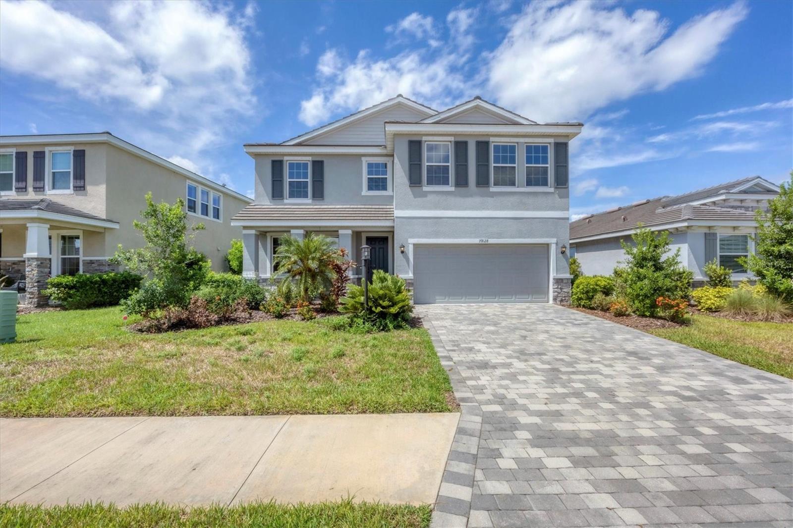 STAR FARMS in Lakewood Ranch where resort-style living awaits in this exceptional 4-bedroom, 3-bath home with additional den and large bonus room on an expansive lakefront homesite featuring 2,756 sq ft of thoughtfully designed space. This Caroline Emerald model includes a versatile 20x11 bonus room with a closet, ideal for a media lounge, playroom, or private guest retreat, plus a separate main level den/office for added flexibility. The open-concept layout showcases tile flooring in the main living areas and plush carpeting in the bedrooms, creating a warm and inviting atmosphere throughout. The gourmet kitchen is a chef’s dream, featuring upgraded black stainless steel appliances, a gas range, and a large center island perfect for entertaining. The home also includes a washer and dryer, two walk-in closets in the primary suite, and Southwestern exposure that fills the space with natural light. Step outside to enjoy the extended, covered paver lanai overlooking a tranquil water view—fully fenced for privacy and ideal for relaxing or hosting gatherings. An EV charger is installed and ready to use, adding convenience for eco-conscious living. Star Farms offers an unparalleled lifestyle with exclusive amenities such as a resort-style pool with tiki bar/restaurant, coffee house, clubhouse, state-of-the-art fitness center, pickleball and tennis courts, basketball court, baseball diamond, playground, park, and scenic walking trails. Zoned for the BRAND NEW LAKE MANATEE SCHOOL with additional A rated schools nearby. Located just a short drive from Lakewood Ranch Main Street, Waterside Place with a variety of shopping and dining options plus easy access to Gulf Coast beaches, cultural attractions, and a vibrant mix of dining and shopping. One pet may be considered—making this home even more welcoming for your furry family member.