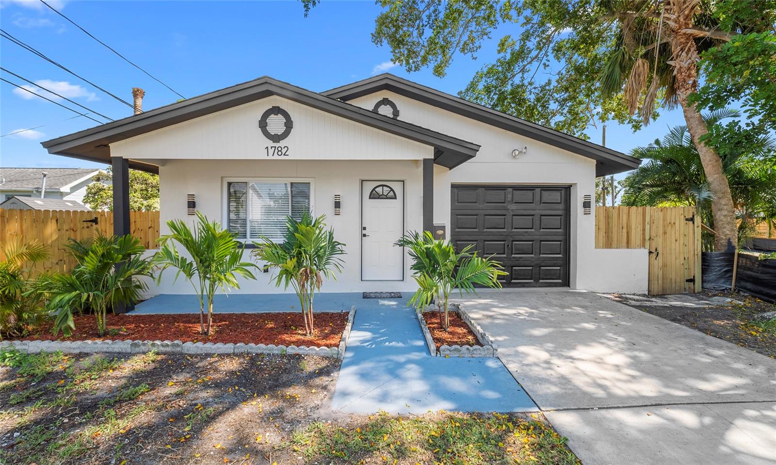 MOTIVATED SELLER, WILLING TO HELP WITH CLOSING COSTS! Live the perfect blend of comfort, style, and convenience in this fully renovated home located just minutes from downtown, beaches, and everyday essentials. This beautifully updated 2-bedroom, 2-bathroom property offers 990 square feet of thoughtfully designed living space and is completely move-in ready. Recent upgrades include a brand-new roof, new electrical system, full plumbing repipe, new water heater, and an AC unit just 3 years old—giving you modern comfort and peace of mind. Inside, you’ll find new flooring, fresh interior and exterior paint, new baseboards, and all-new interior doors that create a clean, cohesive look throughout. The bright, modern kitchen features light shaker cabinetry, a breakfast bar, and brand-new stainless steel appliances with warranties. Both bathrooms have been completely remodeled with sleek, contemporary finishes. A 1-car garage and new fence add extra privacy, functionality, and curb appeal. Conveniently located just 12 minutes from the St. Pete Pier, 25 minutes from St. Pete Beach, Treasure Island, and Tampa International Airport, and only a short drive to grocery stores, gyms, pharmacies, banks, and more, this home offers the ideal balance of tranquility and accessibility. Every inch has been upgraded with care and quality—ready for you to move in and enjoy.