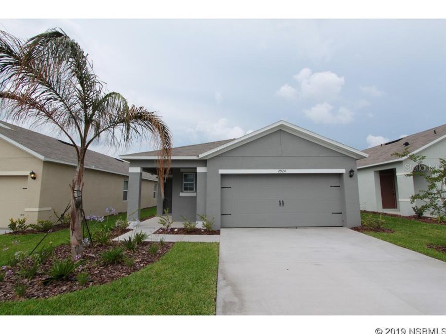 Location! Location! Location! On The water with water features! Just minutes from the beach, Best location in town! Take a bike ride on the trail to downtown shopping and dining in New Smyrna Beach. The Hollandale welcomes you into the Foyer and leads you into the large Great Room to an Open Kitchen Walk past the Living area onto your covered patio were you will enjoy those outdoor events with friends and family. The third bedroom can be used as a an office, study or a den. This must see home comes with the all the extras including SMART HOME features, refrigerator and blinds!! Smart Home features include sky doorbell that activates when the doorbell is pushed. Remotely lock/unlock the door, open/close garage door and activate your porch light. It also comes with Alexa and Alexa Dot and an alarm can be added as well as cameras! Save money with the highly energy efficient 15 SEER AC, dual pane low E windows, radiant barrier and Builder warranty. This home won't last long!