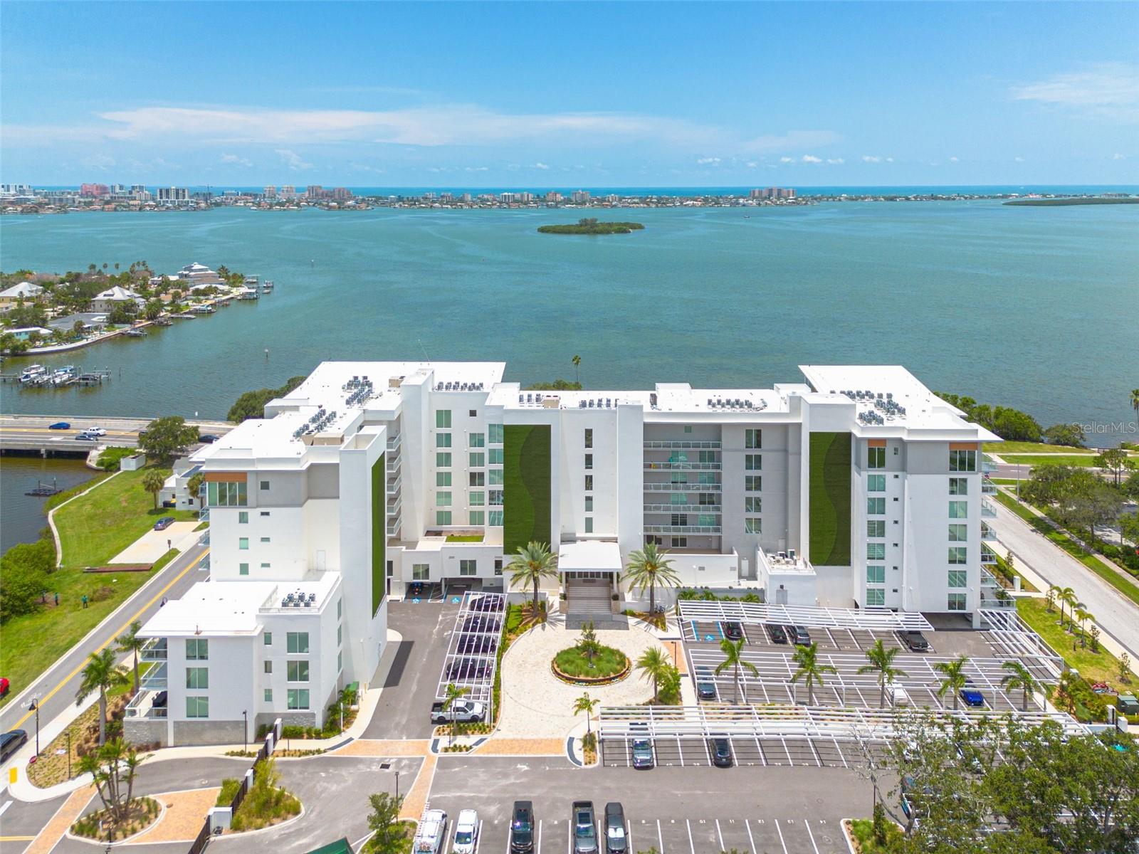 Welcome to residence 213, a thoughtfully curated 3-bedroom, 3-bath Coastal residence within the gated, award-winning Community of Serena by the Sea. Known for its cutting edge, wellness forward, resort style amenities, Sunsets & all concrete construction.
This rare corner unit provides southwest views of Stevenson's Creek and the intracoastal waterways of Clearwater, FL. Oversized windows frame the beauty that is just beyond, and naturally aluminates the space. Notably, this unit is in the south tower with only 3 residences per floor.
Inside, a blend of natural white oak hardwood flooring, and Marbled Porcelain tile adorn the space. All bedrooms feature an ensuite bathroom and Custom Italian Hand Crafted Closets with integrated L.E.D Ambient Lighting.
The kitchen Features sleek Italian Cabinetry, L.E.D. Lighting, Imported German, Gaggenau Gas Cooktop, Oven, & Microwave. The focal point being the Expansive Stone Waterfall Edge Kitchen Island. The large slider gives way to the beautiful terrace with gorgeous water views.
The owner’s suite features a walk-in closet with custom Italian built-in closet system, & Spa like ensuite, equipped with recessed lighting, a floating dual sink vanity, finished with Quartz Countertops, L.E.D. backlit mirrors (anti fog features), & Frameless Glass Shower.
What separates Serena by the Sea is not only the location, or the thoughtfully curated details throughout. It is the 23,000 sq/ft of 5 Star luxury amenities. Whether it’s the Infinity Edge Heated Saltwater Pool, private cabanas, State of the art Fitness center, 2 Covered Grilling Pavilions, Firepit Lounge, Jetted Hot tub, dog run & wash station. The private Spa Club features a Cedar Plank Sauna, Private massage suites, Salon/makeup studio, meditation lounge, Saltwater jacuzzi, & Cold Plunge Bucket.
In this exclusive community of just 80 residences, feel confident you are buying the highest level of luxury our area has to offer! From the full-service Concierge staff to endless sunsets this is the Premier place to call home in Tampa Bay!