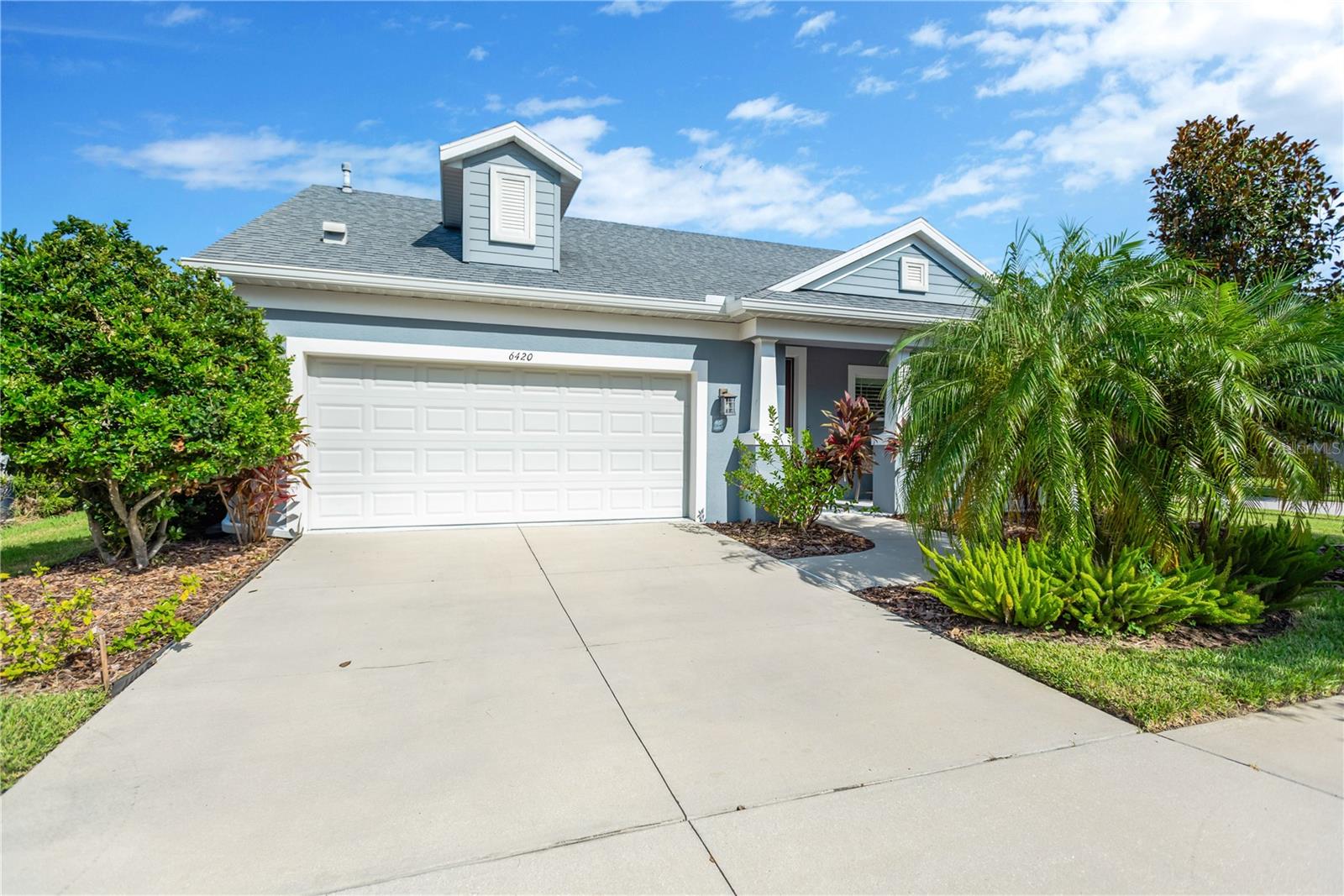 Enjoy Florida living at its finest with this meticulously maintained, fully furnished pool home. The large Kitchen island with quartz countertops, top wood cabinets with 42" uppers and staggered tops and fronts overlooks the Living Room and Dining Room in the common living area . The Walk-In Pantry provides ample storage and the "stainless steel" appliances include a gas range, refrigerator, microwave and dishwasher. Enjoy Pool views and tons of natural light in the Dining Room which has windows on two walls and light from two directions. The eating space here is supplemented by countertop dining at the Kitchen Island. The generously sized Living Room overlooks the Pool and features Tray Ceilings and Crown Molding. At the front of the home, the "Leisure Room" was most recently used as an Office. This flexible space could serve a variety of uses and it features double doors, plantation shutters, and a ceiling fan. Bedroom 3 and the Hallway Bathroom are next door to the Leisure Room. The Hallway Bathroom is a full bathroom with quartz countertops and upgraded tile work on the floor and in the shower/tub surround. The Guest Suite, a second bedroom with an en-suite bathroom, is across the hall from the 3rd Bedroom. The en-suite bathroom is a full bathroom with a shower (no tub), more quartz countertops and more of the upgraded tile work. Next door is a spacious Utility Room that has storage cabinets, a utility sink, and includes a washer/dryer. The Owner's Suite is located at the far end of the home. Natural light cascades into the Sitting Room area at one end of the Bedroom while, at the opposite end of the room, are two Walk-In Closets and the Owner's Spa/Bathroom Retreat. Dual sinks and a Roman Shower lend a feeling of opulence to the space and a water closet ensures privacy. The living space flows to the outdoors in the Lanai and Pool Area. The "saltwater" Pool is fully automated and boasts programable LED Lighting and the privacy screens can be left open for a view of the professionally designed tropical landscape or closed for complete privacy. This home is beautifully furnished with upgraded finishes and features. Hardwood floors flow throughout most of the home with tile floors in the 3 bathrooms and the Utility Room. Tray Ceilings and Crown Molding lend a touch of elegance to the cozy, open-concept common living areas, the Foyer, and the Owner's Bedroom. Waterset is a lifestyle community bringing a variety of amenities for you to enjoy including parks and playgrounds, trails and pools, clubhouses and fitness centers, and so much more. Located in Apollo Beach just minutes from Interstate 75 or US 41, Waterset is a quick commute to Tampa and beyond. This home won’t last long so make your appointment to see this lovely home in this amazing community today!