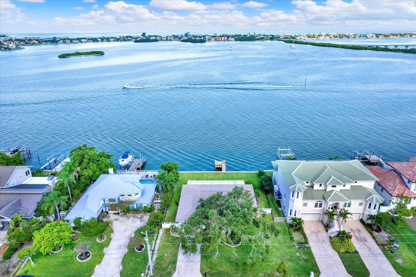 ENJOY THE AMAZING VIEWS FROM THIS WATERFRONT HOME in the sought after area of HARBOR BLUFFS on Driftwood Lane! UNBELIEVABLE LOCATION WITH AMAZING SUNSET VIEWS from inside this home or sitting on the dock of the property that overlooks the IntraCoastal Waterways and the Belleair Bridge. This is a 3 bedroom, 2 bath, 2 car garage home with a dock that is Located on a cul-de-sac. There is a neighborhood park that has seasonal events for adults and kids, including “music in the park.” The Belleair Causeway Boat Ramp is less then one mile away and less then 2 miles to the beaches. Pinellas County sent a letter to the seller verifying that this property is not considered “substantially damaged.” This would allow repairs and improvements for the property to take place without the home being required to be “lifted.” Seller states that there is an “Assumable Allstate Flood Policy” in place. This home is also located in a Deed Restricted Community and they do not allow for short term rentals. PLEASE BE SURE TO CLICK ON THE STUNNING VIDEO TOUR THAT IS ATTACHED TO THIS LISTING