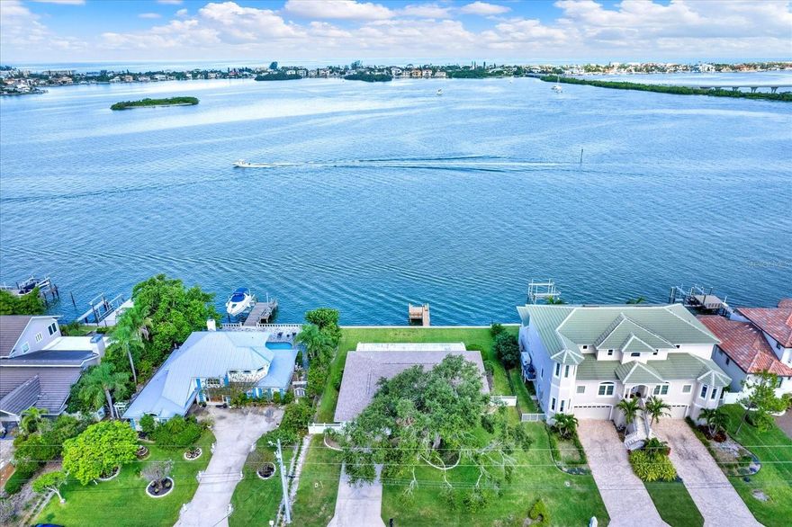 ENJOY THE AMAZING VIEWS FROM THIS WATERFRONT HOME in the sought after area of HARBOR BLUFFS on Driftwood Lane!  UNBELIEVABLE LOCATION WITH AMAZING SUNSET VIEWS from inside this home or sitting on the dock of the property that overlooks the IntraCoastal Waterways and the Belleair Bridge.  This is a 3 bedroom, 2 bath, 2 car garage home with a dock that is Located on a cul-de-sac.  There is a neighborhood park that has seasonal events for adults and kids, including “music in the park.”   The Belleair Causeway Boat Ramp is less then one mile away and less then 2 miles to the beaches. Pinellas County sent a letter to the seller verifying that this property is not considered “substantially damaged.” This would allow repairs and improvements for the property to take place without the home being required to be “lifted.”  Seller states that there is an “Assumable Allstate Flood Policy” in place.   This home is also located in a Deed Restricted Community and they do not allow for short term rentals.  PLEASE BE SURE TO CLICK ON THE STUNNING VIDEO TOUR THAT IS ATTACHED TO THIS LISTING