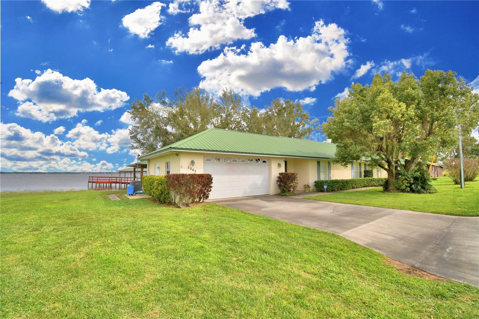 Welcome to the Lake - 3 Bedroom, 2 Bath on Lake Reedy, FAA approved for Sea Planes . Mother In Law suite POSSIBLE with garage conversion. What an amazing home. Metal roof, Laminate & tile flooring and amazing views thru a wall of windows looking over the water. The open concept creates a shared space and is perfect for gatherings with the kitchen flowing into the dinette area and seamlessly joining the living room all with views of the lake. Galley kitchen, tall counters perfect for extra bar stool seating. Split floor plan, the master has walk in closet, en-suite bathroom with double sinks, tall counters, walk in shower with beautiful tile insets and assistance bars. The laundry room/closet has tile floor and Washer and Dryer that will stay with the home. 2nd and 3rd bedrooms ore split by a nice size full bath with tub shower combo. Screened Lanai just outside the kitchen allows for peaceful mornings and restful afternoons looking out over the water. Double garage and new dock that is 110 feet long with 16X21 landing/fishing platform, hand rail, jet ski ramp, boat slip that will accommodate a pontoon with cross beam in case a lift is wanted and 340' of seawall. Sunrise is breath taking from the dock, the lanai or inside as you can see from the photos, the breeze is refreshing and the fishing in this lake is well known in this area. She shed is decked out and pergola with lounger is where naps are a must. Public boat ramp a short distance away with floating dock and facilities. Centrally located between both coasts with easy access to Tampa and Orlando airports, Disney, Legoland and so much more. This property is a rare gem. Schedule your private tour today and make this your forever home.