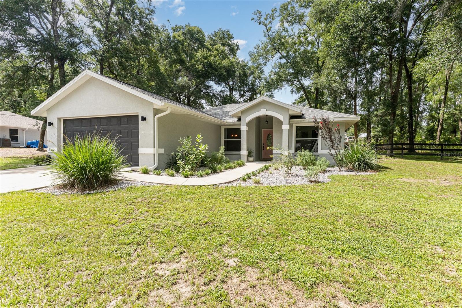 You can change the house (but you won’t need to) but not the location! Selling a newly remodeled 3 bed/2 full bath house in the Inverness Highlands! Built in 2006, this house is in the perfect spot. Set back from Anna Jo down a tree lined driveway. Only a 15 minute drive from Walmart or 8 minutes from Winn Dixie!
The backyard is fenced. Separated down the middle as the owners added a fence to keep dogs away from the French drain along the back of the house.
The orange tree in front produces juice oranges in the winter months. In the next few years the back tree and avocado tree should start as well. There is plenty of room to plant gardens or just enjoy a bonfire or the shade.
The roof was replaced in December 2023. The HVAC September 2023. The interior flooring was installed in spring of 2024 with bamboo engineered hardwood throughout and large tiles in the bathrooms. The side exterior door was replaced in September of 2024 as well as the kitchen cupboards, sink, countertops and range hood. The backsplash is beautiful! The well pressure tank in the garage was replaced in December 2024. There is a drilled well and a septic with a 900 gallon tank which was pumped this summer. Your only utilities will be your electric and your WiFi! The washer, dryer are from 2023 and dishwasher from 2024.
Don’t let the floor plan of 1307 square feet stop you. The layout is outstanding! Spacious enough for a large family who had to move back to another state. Check it out today!