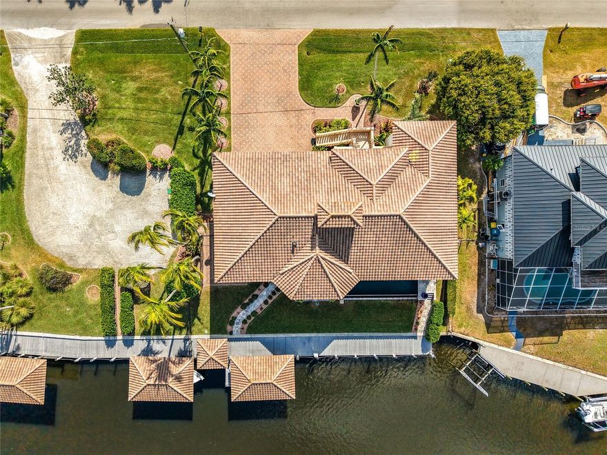 Gulf-Access Waterfront Home | No Bridges | Deep-Water Dock | Punta Gorda, FL
Experience the ultimate Punta Gorda waterfront lifestyle at 24248 Treasure Island Blvd, a rare deep-water, no-bridge Gulf-access luxury home designed for boating, safety, and year-round Florida living. Built with solid concrete block construction, this residence offers over 4,000 square feet of living space, hurricane-resistant features, and an industrial-grade whole-home generator, making it an ideal choice for relocation buyers, second-home owners, and boating enthusiasts seeking peace of mind and fast water access.
Inside, the home features bright open living areas, elegant hardwood floors, and a gourmet chef’s kitchen with solid wood cabinetry, gas cooking, double ovens, walk-in pantry, wine cooler, and a spacious dining area ideal for entertaining. The primary suite offers two walk-in closets, private climate control, a spa-inspired bathroom, and direct access to a full-length screened porch with water views.
Designed for multi-generational living or extended guests, the home includes a private first-floor guest or mother-in-law suite with its own entrance, full bath, kitchenette, and hurricane-impact sliders, plus an additional second-floor guest suite with waterfront views.
Outdoor & Boating Features:
Outdoor living is exceptional, featuring a heated pool and spa, brand-new travertine deck (2024), breezeway access, and a full-width screened porch spanning the entire back of the home. Boaters will appreciate the deep-water canal with NO bridges, providing fast access to Charlotte Harbor and the Gulf of Mexico.
The property includes approximately 100 feet of private dockage with 30/50 AMP power, water, lighting, security cameras, a 62-foot free-span deck for larger vessels, boat house with lift, jet ski bunks, kayak launch, and a climate-controlled tackle and equipment room with custom storage.
Additional features include a fully serviced elevator (2025), oversized 40’ x 33’ garage, central vacuum system, updated alarm systems (2024), multiple storage areas, and meticulously maintained mechanical systems. The home also offers approximately 700 square feet of non-conforming first-level space, ideal for a home office, recreation area, or extended-stay guests (buyer to verify square footage and permitted use).
Homes offering this rare combination of hurricane-resistant construction, deep-water Gulf access, no bridges, luxury features, and move-in readiness are extremely limited in Punta Gorda.
Additional Opportunity:
The adjacent waterfront lot (80’ x 120’) with approximately 92 feet of dockage and two boat lifts is also available for purchase—perfect for expanding your waterfront estate or securing additional vessel capacity.
?? Schedule your private showing today and discover one of the best Gulf-access waterfront opportunities in Punta Gorda, Florida.