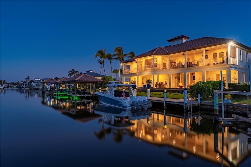 Discover the ultimate Punta Gorda waterfront lifestyle at 24248 Treasure Island Blvd, a rare deep-water, no-bridge Gulf-access estate built for strength, safety, and year-round Florida living. This luxury residence offers over 4,000 sq ft of living space, solid concrete block construction, an industrial-grade whole-home generator, and premium hurricane-resistant features throughout. Ideal for relocation buyers, seasonal residents, and anyone seeking a secure, high-quality waterfront home with fast boating access to open water.
Inside you’ll find bright, open living areas, elegant hardwood flooring, a gourmet chef’s kitchen with solid wood cabinetry, gas cooking, double ovens, walk-in pantry, wine cooler, and a spacious dining area. The primary suite expands the luxury experience with two walk-in closets, private climate control, a spa-inspired bath, and direct access to the full-length screened water-view porch. Designed for multi-
generational or guest living, the home includes a private 1st-floor guest/mother-in-law suite with its own entrance, full bath, kitchenette, and hurricane sliders, plus an additional 2nd-floor guest suite with water views.
Outdoor living is exceptional: a heated pool and spa, brand-new travertine deck (2024), breezeway access, and a full-width screened porch stretching across the entire back of the home. For boaters, this property is unmatched — a deep-water canal with NO bridges, providing fast access to Charlotte Harbor and the Gulf of Mexico. Enjoy an approx. 100' private dock with 30/50 AMP power, water, lighting, cameras, a 62' free-span deck for larger vessels, boat house with lift, jet ski bunks, kayak launch, and a climate-controlled tackle/equipment room with custom storage. Additional features include a fully serviced elevator (2025), oversized 40' x 33' garage, multiple storage areas, central vacuum, updated alarm systems (2024), and meticulously maintained mechanical systems. Home includes 700 sq. ft. of non-conforming first-level living space, perfect for a mother-in-law suite, extended-stay guests, home office, or recreation area. Buyer to confirm square footage and permitted use.
Home offering this combination of hurricane-resistant construction, deep-water access, no bridges, luxury features, and move-in readiness are extremely rare in Punta Gorda. 
An additional opportunity:
The adjacent lot (80' × 120') with approx. 92 feet of dockage and two boat lifts is also available for sale. Perfect for expanding your waterfront footprint or securing additional vessel capacity.