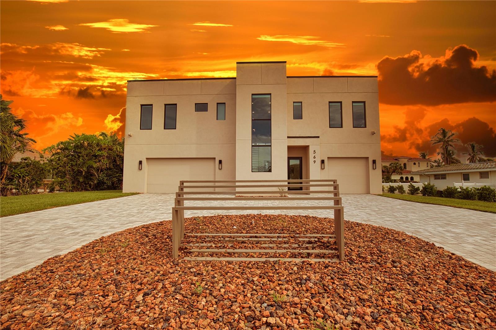 Welcome to Elegant Shores, the newest construction in the highly sought after, rarely available community of Longboat Key Estates. Sleek, stylish, waterfront. Experience luxury living with breathtaking views, this custom home is the pinnacle of modern design. Designed with a minimalist aesthetic and a focus on clean, geometric forms, the plan features an open-concept layout that flows effortlessly from one space to the next. With no spared expense, all materials, finishes, fixtures, and appliances used were all top of the line quality. Even when it comes to the elevator which is oil powered as opposed to electric which will make it last four times longer. Enjoy the option of three different levels, the bottom level which includes two separate garages that can hold a total of 4 cars and has a completed private suite with full kitchen, bathroom, and private entrance. The main level which consists of 3 separate en-suites, an open concept living area, gourmet chefs kitchen, a custom L-shaped quartz island, and a spacious deck with a built in outdoor kitchen. Then there is the top level, a captivating rooftop deck that offers panoramic views any way you decide to look. Look over to the beach, or the other way to the bay, the experience is fantastic overall. Last but not least we have the expansive pool deck with a custom finished pool, modern paver patio, outdoor shower, and your own private boat dock. This residence is very unique and truly offers a tranquil coastal living experience. The property includes deeded beach access, very low HOA fees, and is located adjacent to Bayfront Park, which offers public amenities such as tennis, pickleball, fishing docks, a dog park, and a recreational center. This rare offering will not last, call and schedule your own exclusive showing today.
