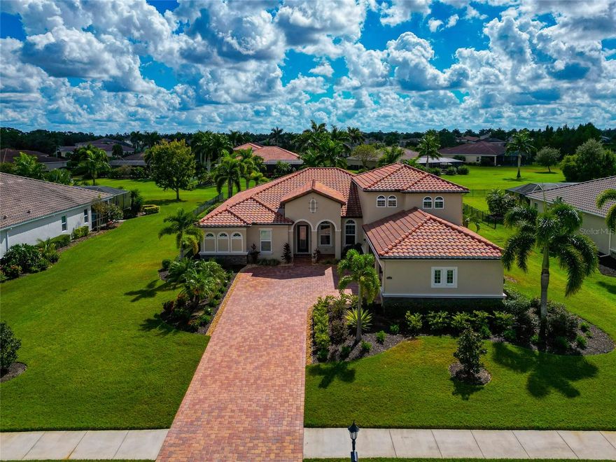 0.54 acre fenced, 5 Bds, 4 BAs, 3+ Car Side Load Garage, Heated Pool & Spa, Tesla Charger, 3892 sq ft, No CDD taxes, Low HOAs, 42' Lanai, New Appliances, Gladiator storage included, Newly Painted interior & Exterior, 10 & 11 foot ceilings, 40 Ft Elevation, Home Office, Huge Bonus rm.   Your wait for the perfect home is over … Welcome to this 3892 sq ft masterpiece, offering 5 BDs, 4 full BAs, a bonus room, family rm, living rm, and private home office—all designed for comfort, style, and function. Located in the never disappointing Rye Wilderness community, known for its ½-ACRE PREMIUM LOTS, TILE ROOFS, PAVER DRIVEWAYS W/ SIDE-LOAD GARAGES, This home delivers elegance & comfort inside and out. Step through the front door and be impressed by architectural details including double COFFERED 10 & 11 FT CEILINGS, crown molding, and extensive custom millwork. The open split floor plan ensures privacy for everyone while maintaining seamless flow for entertaining and everyday living. The gourmet kitchen is a chef’s delight & entertainers dream, featuring GE PROFILE STAINLESS-STEEL BUILT-IN APPLIANCES, solid wood cabinetry, GRANITE countertops, cooktop with hood, breakfast bar, island, and WALK-IN PANTRY. The REFRIDGERATOR, DISHWASHER, & COOKTOP UPGRADED in 2024, ensuring both style and performance. The 20X17' PRIMARY ENSUITE is a luxurious retreat at the end of a long day with ceramic tile flooring, tray ceiling with crown molding, his and her closets, and private access to the lanai. The spa-inspired bath includes a large custom glass WALK-IN SHOWER, DOUBLE GRANITE VANITY, & SOAKING TUB. This model also includes a 2ND ENSUITE BEDROOM, perfect for VIP guests or MULTI-GENERATIONAL LIVING.  Step outside to your own private oasis—a 41’ x 43’ lanai with large undercover area, featuring a gorgeous HEATED POOL W/ SPA (25X13). Lanai has Upgraded NEW wood ceiling, NEW recessed LED lighting, and NEW ceiling fans. This great outdoor living is surrounded by lush, mature landscaping and a fully fenced backyard— boosting its privacy. Fabulous 25.5 x 21.5' BONUS RM w/ new carpet and FULL BATH offering so many possibilities for this space.  The 3+ CAR SIDE-LOAD GARAGE is a showstopper in itself, featuring TESLA CHARGER, EPOXY FLOORING W/ RACE DECK MODULAR FLOORING, GLADIATOR CABINETS, WORKBENCH & FRIDGE, all included with the sale. Laundry rm has 42' wood cabinets on both sides, upgraded stainless steel sink, New WASHER & DRYER. 
Additional upgrades include Entire INTERIOR & EXTERIOR professionally PAINTED 2024 & 2025, New ceiling fans and LED recessed lighting with dimmers throughout, all bedrooms upgraded to ceramic tile flooring & so much more. This home truly has it all—luxury finishes, thoughtful upgrades, and timeless design—all nestled within one of the area’s most desirable community.