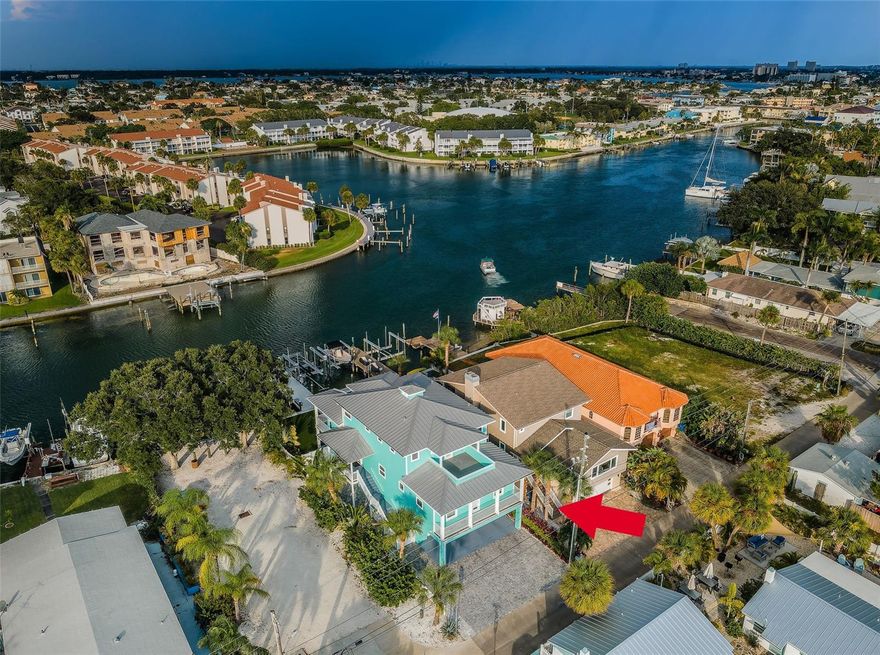 THE BEST OF BOATING AND THE BEACH!  Tucked away in a quiet waterfront neighborhood, you’ll feel the Old World charm of Florida in this attractive, contemporary Key West style home with 6195 total sqft under roof.  Offering uncluttered finishes and an authentic yet informal Key West appeal, you’ll love the coastal vibe of this wonderful residence.  A covered entry porch welcomes you to a terrific open concept great room plan with luxury vinyl wide-plank driftwood-style flooring, appealing window treatments, built-ins for media entertainment and excellent waterviews. From your light & airy living area, step out to a generous 29ft-wide, 290sqft covered balcony overlooking the water – an area perfect for entertaining, day or night.  Your impressive open-concept kitchen boasts quartz counters, coastal cabinetry, a large island prep/service center, quality appliances, ample waterfront dining, and a sizable walk-in pantry.  Double doors open to a fine contemporary office.  Hallway leads to two spacious bedrooms with unique interior transoms and large walk-in closets.  Bedroom two is en suite, with a well-appointed full bath with elegant vanity and superb walk-in glass shower with splendid tilework.  The posh guest bathroom provides a graceful vanity and a pleasingly-tiled glass shower enclosure with tub.  A wide, west-facing balcony supports the two guest bedrooms and is a great outdoor covered seating space.  Upstairs you’ll find the immense owner’s suite, with its grand owner’s bedroom/sitting area opening to a partially-covered 175sqft deck with sweeping views of the waterfront.  Two huge walk-in closets with closet systems transition to a rich owner’s bath with lovely coastal vanities and an inviting glass-enclosed shower system with body spray.  Within the suite rests a 140sqft multi-purpose area that opens to a 175sqft front-facing balcony – you’ll adore the dazzling sunsets and partial Gulf views seen from this location.  Step out back to the 300sqft covered lower-level deck; a brick paver path leads you past an updated seawall to an outstanding composite dock with 20,000 lb boat lift and a separate slip for a 50ft+ cruiser.  Home has an exceptional indoor laundry with storage, an oversized garage with epoxy flooring plus a substantial multi-purpose storage area that opens to the lower deck.  Why choose? Just 5 minutes to Gulf by boat and just two blocks to the powdersoft sands of Treasure Island’s beach!  Measurements are estimates, buyer to verify.