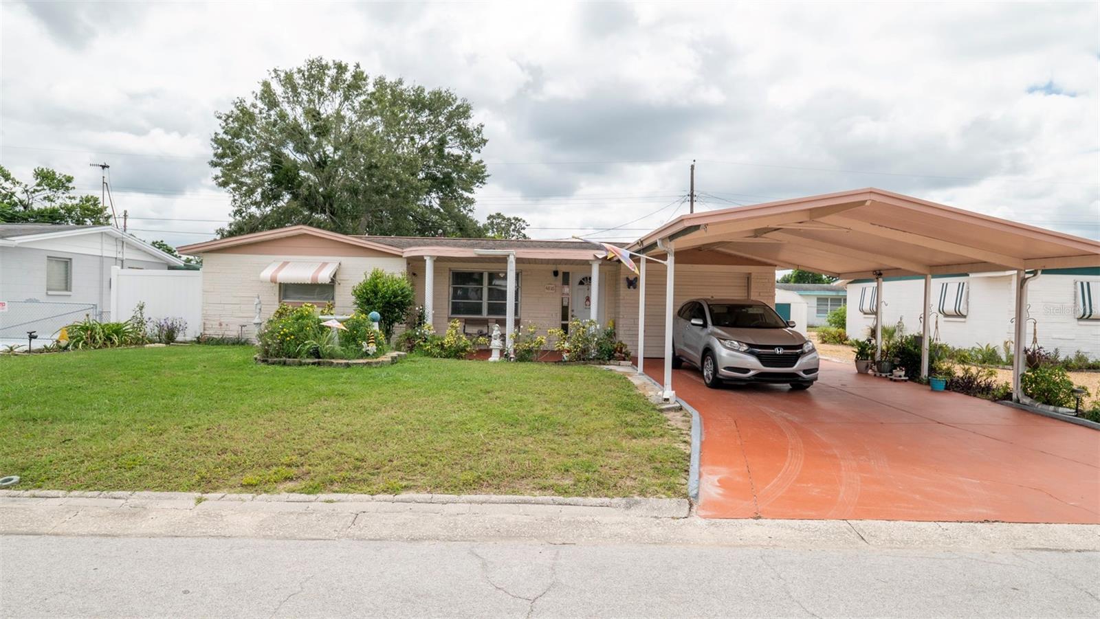 Welcome to your dream home in the charming town of Holiday, FL! This beautiful single family home boasts 2 bedrooms, 1 bathroom, and 1200 square feet of living space. The attached 1 car garage and double carport provide ample parking for you and your guests. The split garage also includes a craft room with A/C, perfect for all your DIY projects. Step inside and be greeted by the updated kitchen featuring formica countertops, new cabinets, and tile flooring. The bathroom has also been recently updated, adding a touch of modern elegance to the home. Enjoy the Florida sunshine on the covered lanai, perfect for outdoor entertaining. Located in a peaceful neighborhood, this home is just a short drive away from local beaches, restaurants, and shopping. Don't miss out on the opportunity to make this your new home sweet home!
