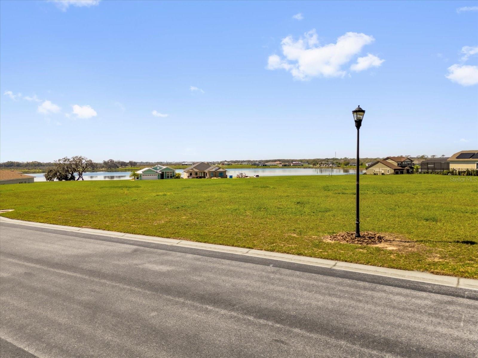 Beautiful Water Ridge!!! Build the home of your dreams in this hidden amazing gated private waterfront community with three large pools, gym, multiple tennis courts, conference center, boat ramps, fishing docs on world-class bass fishing lakes, and so much more! Near I-4 between Orlando and Tampa; Florida Polytechnic Campus Nearby; Gated Water Ridge Polk County Parade of Homes Award Winner Community. Bring your own builder and plans and enjoy the Underground Utilities sewer, water, electric ; Lake Alfred and Lake Van views surround the community; Level Lot, walking distance to Playground, Pool & Cabana, and Tennis Courts.