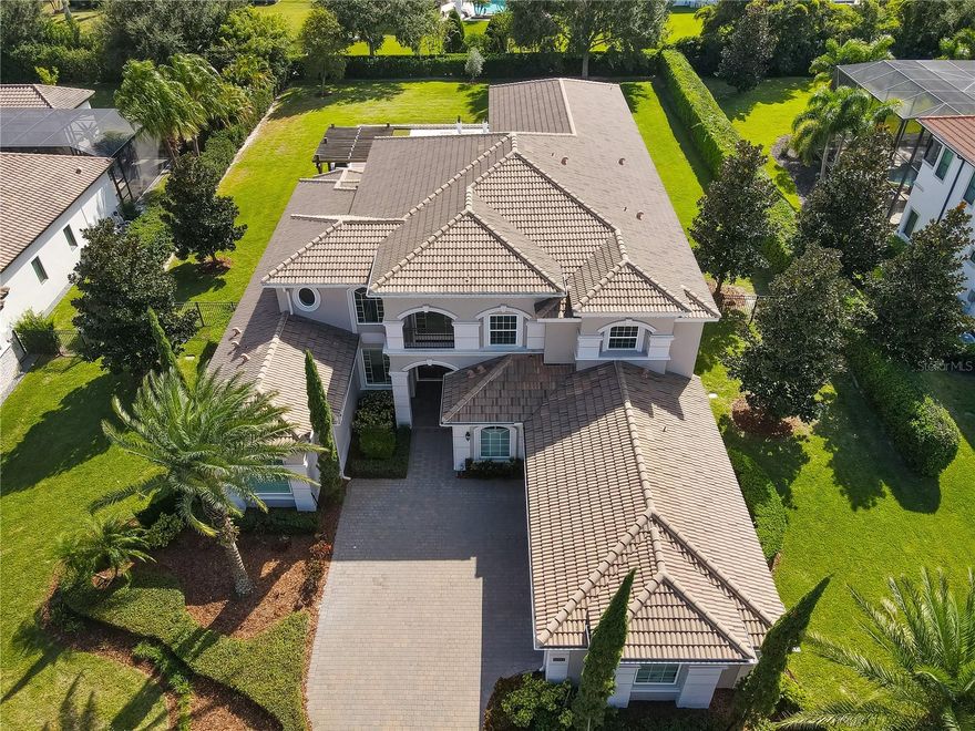 Price improvement!. Welcome to This exquisite luxury residence is the epitome of sophistication, offering an unparalleled living experience in the sought-after, guarded & gated Bellaria Community. As you step through the grand entrance, you'll be captivated by the spacious, open layout, two-story ceilings, and abundant natural light. The gourmet kitchen features modern quartz countertops, custom cabinetry, a generous island with seating, top-of-the-line stainless steel appliances, and a convenient beverage cooler. This premier home offers contemporary floors and luxurious light fixtures. Downstairs are two huge Master suites: The primary room has high ceilings, double walk-in closets with custom cabinetry, and an extended Master corridor. The bath features a standalone tub, two showers, and two commodes, among other luxurious features. The additional bedrooms feature 4 ensuite baths. Capturing some of the best resort-style living in Florida, you can enjoy your private backyard oasis with an inviting sparkling saltwater heated pool and spa, an outdoor summer kitchen, a beautiful Gazebo with a Barbecue grill, outdoor pizza oven, and a gas fireplace, making this the perfect home to entertain. Expand your entertaining outdoors onto the extensive lanai, which features marble floors in all the Pool areas, or enjoy the 3/4 +/- acreage & approximately 120' wide lot. This home is perfect for both family life and entertaining guests. Located in the highly sought-after Bellaria community with a 24-hour staffed gatehouse and just 65 home sites, you'll enjoy Windermere's serenity while just minutes away from top-rated schools, shopping, dining, health centers, and all the magic of Orlando. Sellers are motivated and considering all reasonable offers.