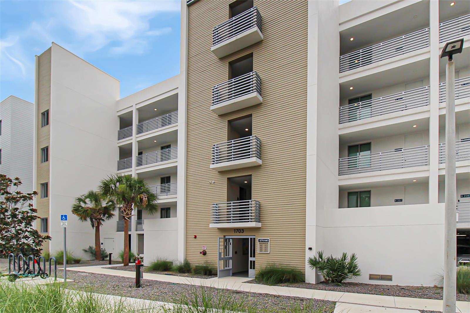 Welcome to Admirals Watch, your luxurious 5th-floor retreat in The Strand, Sarasota, offering treetop views of Sarasota Bay and Longboat Key! This stunning 1-bedroom, 2-bathroom unit with an additional den, complete with a Murphy bed, offers flexible space for guests or a perfect remote office setup. Furnished with brand-new, modern furniture, every detail is designed for your comfort and style.
Upon entry, you'll be greeted by a bright and inviting atmosphere. To the right of the foyer, the primary bedroom features luxury finishes, a spacious closet, and an ensuite bathroom with a large vanity and a stunning walk-in shower. Down the hall, you'll find a second bathroom with a lovely vanity and a shower/tub combo. The adjacent den, equipped with a Murphy bed, can serve as additional sleeping quarters or a remote office with its convenient desk.
At the end of the hall, the main living space beams with natural light from the sliding glass doors. The living room, featuring a plush sofa and a Smart TV, opens to a balcony with outdoor seating for two, perfect for enjoying your morning coffee while overlooking the pool and distant views of Sarasota Bay. In the evening, unwind and take in the stunning sunsets over the Gulf after a long day at the beach. The sleek kitchen boasts stainless steel appliances, and the dining table seats four comfortably.
Guests of The Strand enjoy a range of luxury amenities, including a fitness center, a resort-style pool and spa, a gated community, a fire pit, and a kayak launch. With its prime location near Downtown Sarasota, you'll have easy access to world-class dining, shopping, museums and entertainment options.
Parking is a breeze with two reserved spots: one in the building's garage (Spot #129) and one outside near the pool (Spot P-229). Admirals Watch is conveniently located in the first building, 1703, upon entering the gate.
House Rules: No smoking or burning candles inside the lodging. No parties. No Pets. Amenity fob and keys must be left in the unit prior to departure to avoid a $150 fee. Your reservation may require completing a Homeowners Association application with personal details.
Come experience the luxurious lifestyle at Admirals Watch!