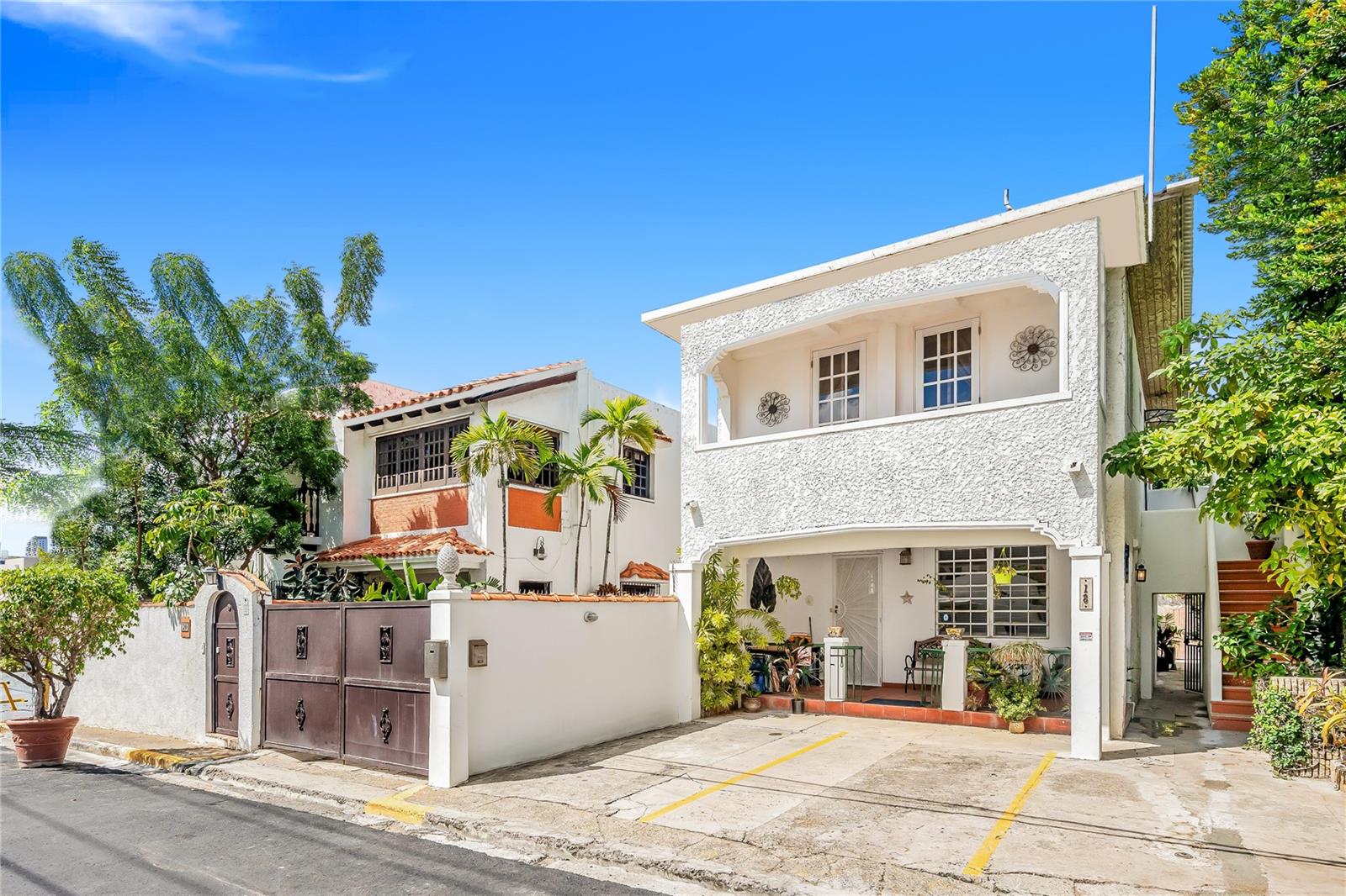 Unparalleled potential featuring two adjacent properties spread over 5 units on the most sought-after beach block in San Juan. Outside of the Ocean Park flood line, remarkable opportunities of this caliber are rare. Nestled on Calle Yardley, mere steps from the widest expanse of beach in Ocean Park, this one-of-a-kind compound offers an extraordinary lifestyle while generating significant investment income.
This property currently enjoys the full benefits of an issued Act 60 tourism decree, including
-40% tax credit on all improvements to the property
-0% sales tax on all materials and equipment purchased for the property operations and improvements.
-75% discount on all property taxes
-4% corporate tax on profits of the business.
-0% tax on all profit distributions.
-inquire about various other benefits.
A generous total of 4,802 interior sqft spread over 11 bedrooms and 6 bathrooms - these fully furnished properties present a wide range of opportunities. Currently operating as a Bed and Breakfast registered with the government of Puerto Rico and benefiting from transferable tax credits and tourism decree, new owners can continue operating the current business, reside and long-term rent, or completely redesign a dream home on this large 686 square meter lot. This property is presented as five separate residences, offering a diverse array of living options.
The main house at 20 Calle Yardley Place is a stunning two-story Spanish-style villa featuring 4 beds/2 baths and 1,976 sqft of living space. It showcases exquisite terracotta tiles throughout, complemented by elegant wooden accents. Glamorous French doors open to an airy floor plan that seamlessly connects the living room and dining area. Impressive 10-foot ceilings enhance the rich tones and numerous windows invite abundant tropical sunlight. The thoughtfully designed kitchen is equipped with custom cabinetry and adorned with Spanish tiles and includes modern amenities such as an extraction fan, a dishwasher, and generous storage. Step outside to the expansive back patio, which features a barbecue grill and a beautifully landscaped area ideal for relaxation or entertaining. The first floor also features a large office space. Ascending to the second floor, you will find three well-appointed bedrooms. This main residence combines historic elegance and functionality, including a 4-stage water filtration system and a 600-gallon water cistern.
Behind the main residence are two beautifully furnished apartments. The ground floor apartment is 438 sqft offering 1 bed/1 bath, an open concept kitchen, dining, and living area. The layout is spacious and cozy, maximizing comfort. The second-floor apartment is 741 sqft and includes 2 beds/1 bath. The living area is adorned with unique, original tile flooring and opens onto a private balcony, complete with a hammock perfect for enjoying morning coffee. This unit features a separate and private roof-top terrace that provides breathtaking ocean views.
The independent building adjacent to the main house at 18 Calle Yardley features two additional boho-chic apartments.
The vibrant local community, combined with its proximity to Condado Beach, renowned dining establishments, and top-ranking schools, makes this location a magnet for both residents and tourists.
