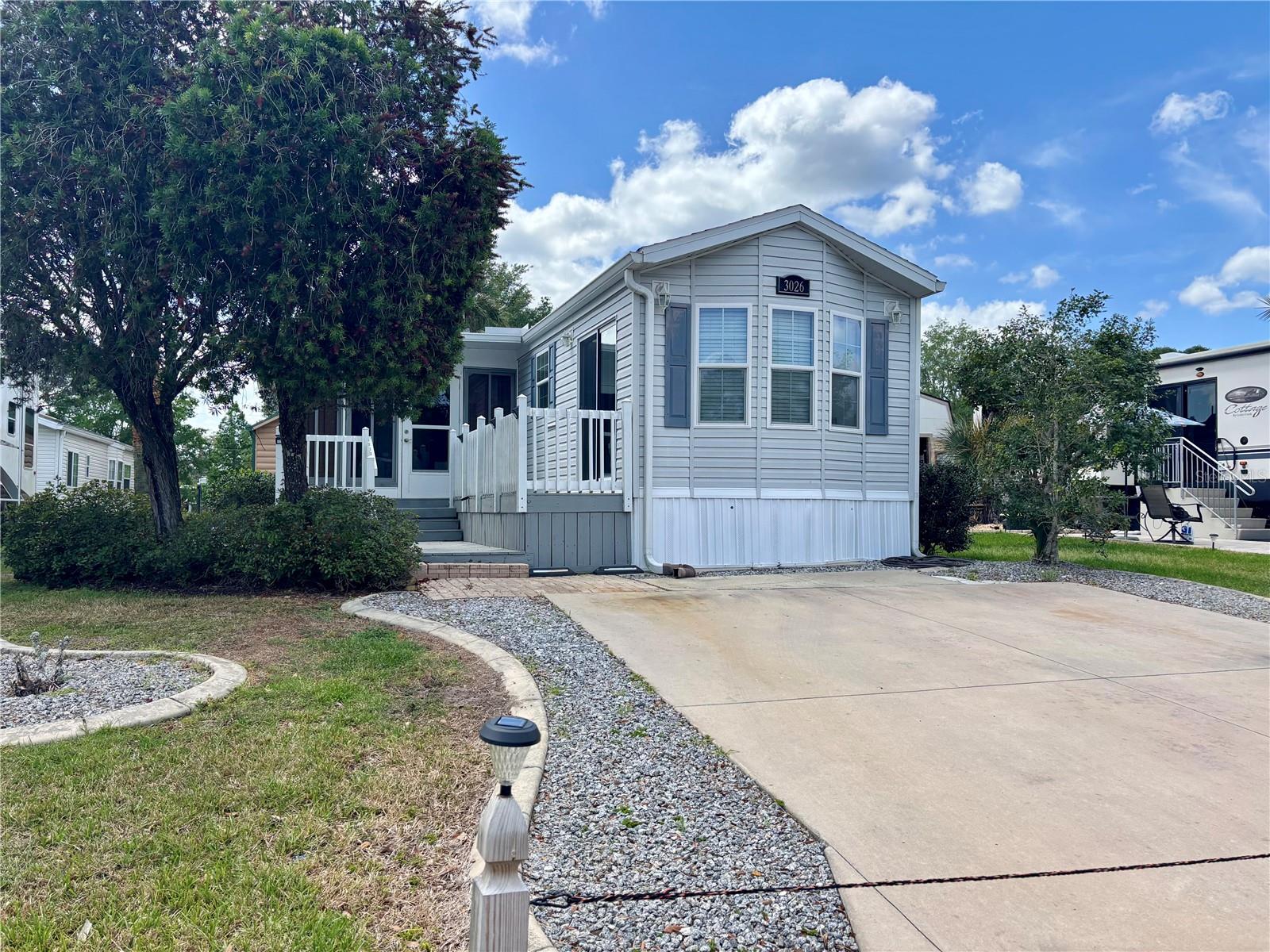 Desirable Wilderness RV Park!!!!Located minutes from Silver Springs State Park, shopping, restaurants, historic downtown Ocala and 1 hour from Ormond beach. This is the one you have been waiting for!! This park model features 1.5 baths with attached sun room and storage room that could easily be converted into another bedroom, making this a potential 2 bedroom with 1.5 baths! Master bedroom is an oasis with large walk in closet and private en-suite with large shower. Truely a one of a kind park model with its open bright layout, extra room and 1.5 baths. Home comes furnished and includes washer, dryer, dishwasher, refrigerator and range. ROOF REPLACED IN 2023 AND AC REPLACED IN 2015. Enjoy the Florida sunshine on the large attached deck. Plenty of parking for 2 vehicles. Amenities abound with clubhouse, community pool, shuffleboard and fitness center. You also have access to the Ocklawaha River and Greenway Trails for hiking. Please note that you own the land and the lot is deeded in your name.