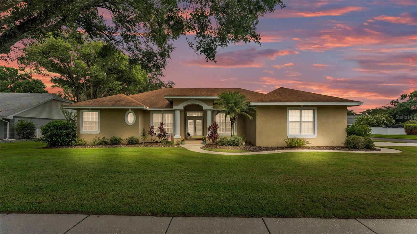 Welcome to 3717 Tigereye Court. Built by Central Florida’s premier custom homebuilder, Ernie White, this stunning residence is located in the coveted Leigh Lakes subdivision of Imperial Lakes. Situated on an oversized 0.31-acre corner lot, this home masterfully blends elegant design, thoughtful updates, and a versatile floor plan perfect for both entertaining and everyday living. Step inside to soaring 10-foot ceilings, detailed crown molding, and an open / inviting atmosphere. This home offers three spacious bedrooms, two bathrooms, a large front living area that sets the tone for refined comfort. The private office provides a quiet space for work or relaxation and the separate formal dining room features a beautiful crafted tray ceiling. The primary suite is generously sized with private lanai access. Recent updates include a new roof (2017), new A/C system (2019), luxury vinyl plank flooring (2024), and a modern metal fence enclosing the backyard. Focusing on the heart of the home, the updated kitchen shines with granite countertops, stainless steel appliances, and tall cabinetry. Ideal for both casual meals and hosting guests. The kitchen opens seamlessly to a generous family room featuring sliding glass doors that lead to the screened lanai, creating a serene retreat. The screened outdoor living space is perfect for gatherings, complete with a convenient pass-through window from the kitchen and ample room for seating and dining. The fully fenced backyard provides plenty of outdoor space as well as safety for pets and children. This home combines quality, scale, and timeless elegance inside and out.
