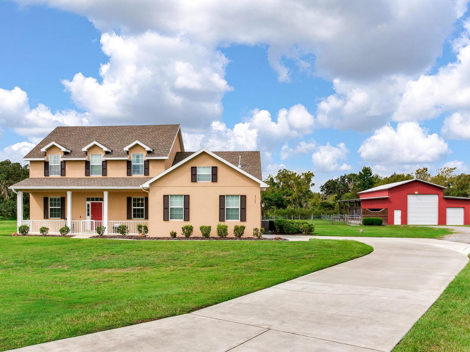 Welcome Home to Your Classic Country Manor on 5+ Acres with Pool and Barn! Discover the perfect balance of rural charm and modern convenience in this gated equestrian community, where each custom home enjoys its own private acreage. Tucked at the end of a quiet cul-de-sac, this traditional residence offers inviting spaces throughout—a cozy front porch, dedicated home office, formal dining room, sunny breakfast nook, and a living room with an elegant electric fireplace. The main-level primary suite provides comfort and privacy, while upstairs you’ll find the perfect kid’s escape with three additional bedrooms, two full baths, and a spacious bonus room ideal for play or study. Outdoors, a 48' x 48' barn features two horse stalls, an enclosed area for boat or RV storage, plus a separate storage room. The property blends lush pasture with mature trees, creating both privacy and plenty of room for animals or your own homestead. Enjoy country living with the ease of a gated neighborhood and community living—your serene retreat awaits!
