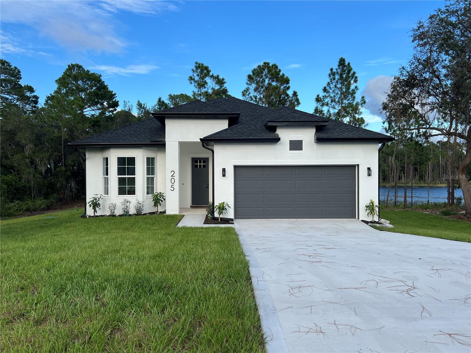 Experience modern luxury in this beautifully crafted 4-bedroom, 3.5-bathroom home situated on a serene wooded, lakefront lot. Built in 2025, this residence combines elegant design with the perfect outdoor lifestyle.
Wake up each morning to breathtaking lake views, framed by soaring 10-foot ceilings and 8-foot doors that fill the home with light and space. The chef-inspired kitchen is thoughtfully designed with upscale finishes, perfect for both everyday living and entertaining.
Step outside to your paved, covered rear porch overlooking the water—ideal for relaxing, dining, or simply enjoying the peaceful surroundings. With a 1/3-acre lot, you’ll have the option to build your own dock for boating, jet skiing, kayaking, or fishing right from your backyard.
This is more than a home—it’s a lifestyle of comfort, elegance, and lakefront living.