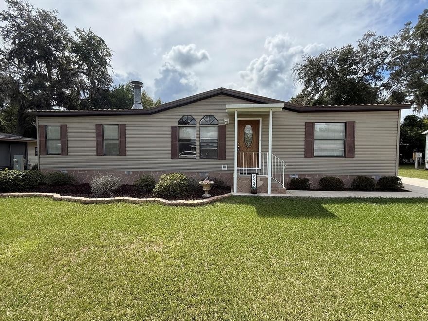 Welcome to this beautifully maintained 3/2 on a quiet Cul-de-sac in Belleview. Home has vaulted ceilings, open floor plan, beautifully tiled floors in main living area. Home has been freshly painted inside, and is move in ready! No worries about the roof, as it has a 2022 metal roof. Home has split floor plan with master bedroom On-suite.
The large kitchen has ample cabinets and an inside Laundry. For those cooler nights, there is an amazing wood fireplace to keep you warm.
Outside has an 18 x 12 screened in lanai to host those cook outs with family, Beautifully landscaped with plenty of room for your fur babies to roam. Property includes an 8 x10 floored outbuilding to give you plenty of storage. Come take a look at this beautiful home!
Close to downtown Belleview, and short drive to Ocala.