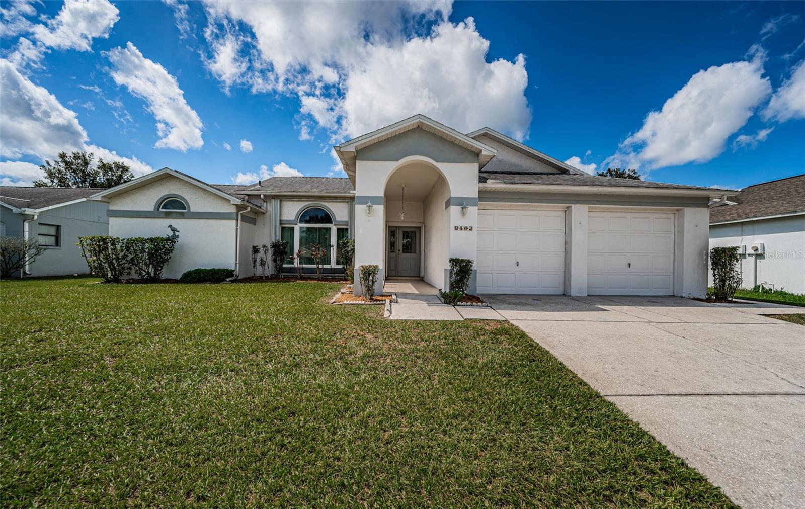 ONE STORY ~ MOVE IN CONDITION ~ WELL MAINTAINED HOME! Pride of ownership home featuring 3 bedrooms, 2 baths, family room, living and dining room combination with 1618 square feet with a 2 car attached garage. This home is welcoming and has a well designed split floor plan. Just inside is the living room, dining room combination featuring high ceilings and laminate floors with a set of French doors to the outdoor space. The kitchen is in the center of the home and opens up to the kitchen nook and family room. The remodeled kitchen includes granite countertops, custom cabinets with a soft close cabinet feature, ceramic tile floors and a view of the back yard out the kitchen sink window. The family room features cathedral ceilings, sliding glass doors that open up to the screened in lanai and tile floors. The oversized primary suite offers two walk-in closets, high ceilings and laminate floors with a private bath including a walk-in shower, dual sinks in the vanity and a separate standard bathtub. The secondary bedrooms are spacious with laminated floors, pitch ceilings and ceiling fans. Additional highlights of this home include new windows, hurricane shutters (2003), inside laundry room and laundry sink including the washer and dryer, screened in lanai, 2 car garage with built in shelving and pull down stairwell for easy attic access and storage plus a separate block built shed out back for more storage. Roof (2017), HVAC (2016) and water heater (2018). This home is located in flood zone X - which means NO FLOOD INSURANCE REQUIRED. Fairway Oaks offers LOW HOA FEES, nestled next to a former golf course. This community has easy access to the Suncoast Parkway, approximately 10 minutes to Hudson Beach and less than 1/2 mile to Publix and convenient to shopping, restaurants, schools, the Veterans Memorial Park which has a 25 yard competition swimming pool facility, the Sun West Adventure Park with wakeboard cable, aqua park, and paddle sport rentals and so much more. TRULY A MUST SEE HOME.