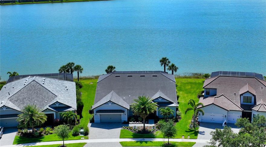 Welcome to Shoreview at Waterside, one of the most coveted addresses in Lakewood Ranch. This pristine coastal residence built in 2020 offers breathtaking, endless wide lake water views from the moment you enter. The rear exposure is southeast, and perfect for kayaking on the lake! The extended lanai is appointed with neutral travertine tile and a custom summer kitchen, complete with stainless-steel gas grill, refrigerator, crushed ice maker, wet bar, and storage. The saltwater pool features a swim shelf and spa that may be heated by natural gas or electricity. The panoramic lanai screen will allow you to enjoy unobstructed water views while socializing with family and friends. 

The home boasts an open concept design with state-of-the-art gourmet kitchen amenities, Brazilian Quartzite countertops, stainless appliances, a natural gas cooktop, built-in oven, convention microwave, and two walk-in pantries. The first level consists of 4 bedrooms plus 3 1/2 bathrooms, and office space. Enjoy the beauty of the neutral rectangular 9” wide plank tile throughout the entire first level. 

The owner's suite features a coffered tray ceiling and luxurious spa-like ensuite bath, which includes dual vanities, extensive walk-in shower along with a huge walk-in closet with kitted out island - perfect for all your fashion needs!  

The second level boasts a large 5th bedroom, full bath, office, PLUS large bonus room perfect for your home theatre needs!  

This light and bright home is tastefully decorated with neutral colors throughout. The owners are using the 1st floor formal dining room as a home office. This amazing property offers endless possibilities to create your own oasis. 

Lakewood Ranch Waterside encompasses seven lakes and 20 acres of shoreline, nature preserves and recreational trails. Enjoy new lakefront Waterside Town Center with a large variety of shopping and dining. Residents at Shoreview enjoy many amenities including a heated resort-style pool and spa, coastal inspired clubhouse, catering kitchen, community gathering room, state-of-the-art fitness center, kayak launch, tennis and pickleball, multipurpose turf lawn, outdoor bar, fire pit, barbeque grills and beach area with hammocks and chaise lounges. Summary of HOA services include lawn maintenance, irrigation, maintenance of common areas, and the two expansive lakes totaling 144 acres. 

Please see the list of post-closing customized upgrades in the MLS attachments. Room Feature: Linen Closet In Bath (Primary Bedroom).